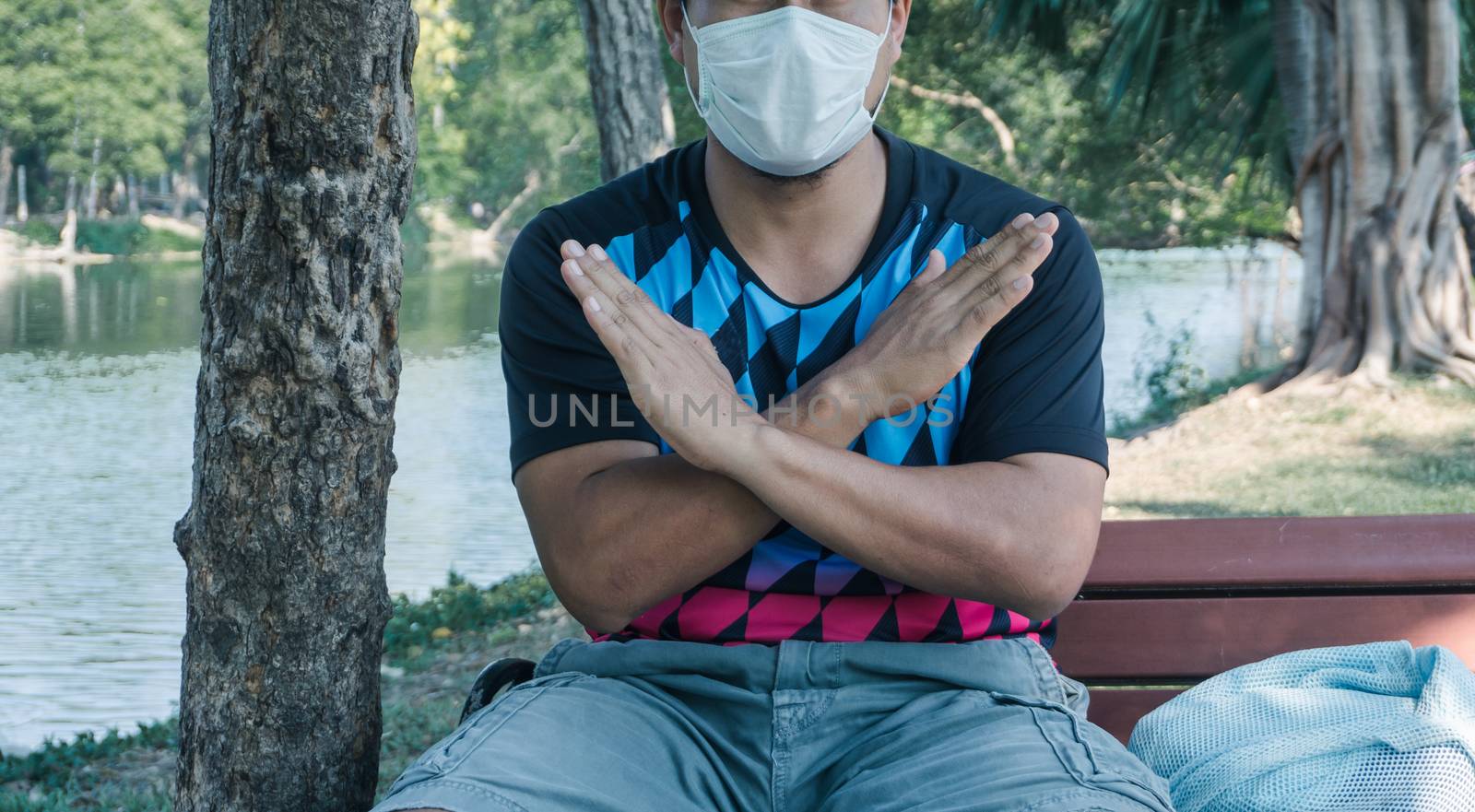 A young Asian man wearing a mask to prevent the spread of the virus. Men are unemployed due to a virus outbreak.