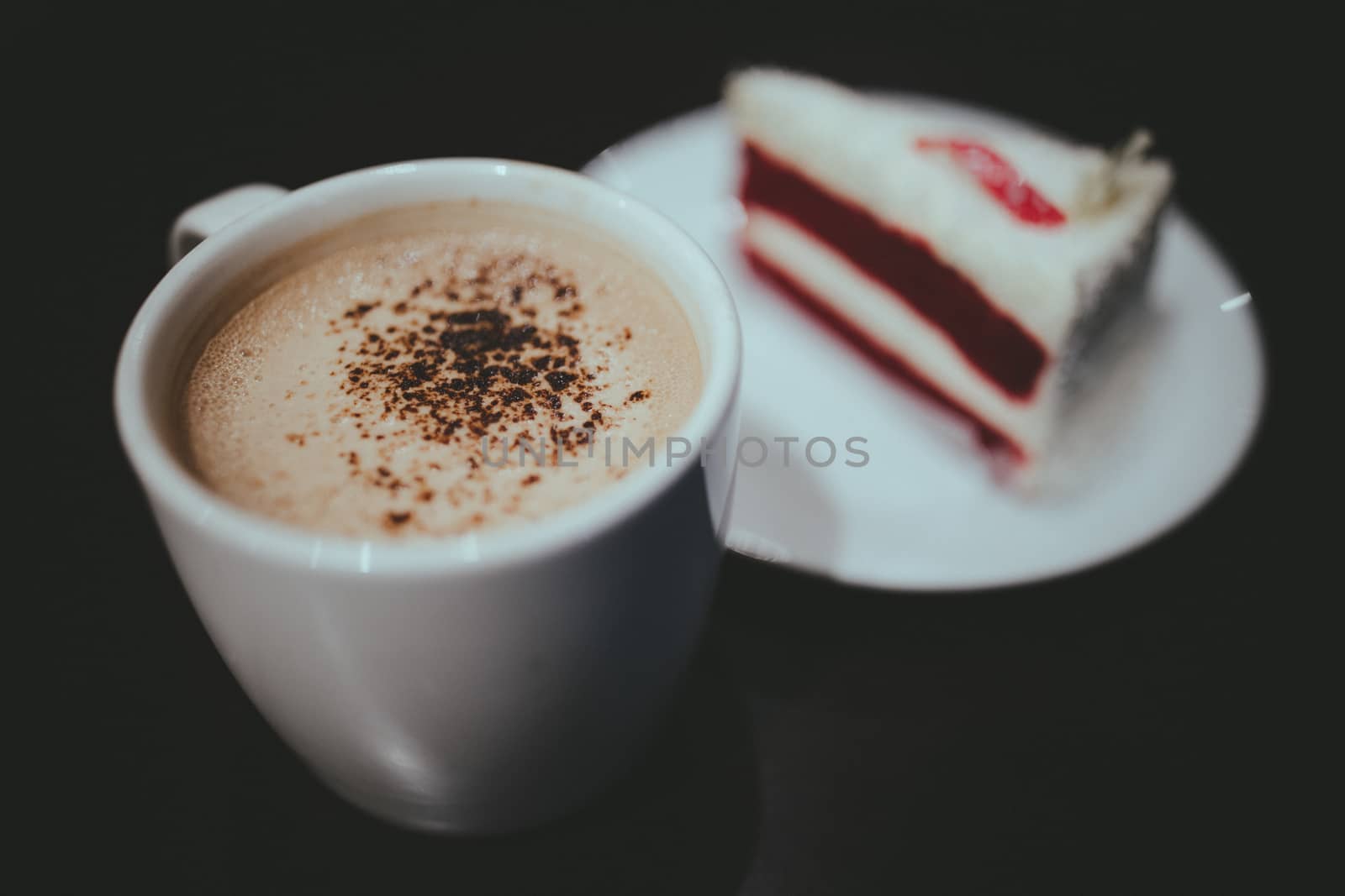 Vintage film look of cappuccino coffee and red velvet cake.