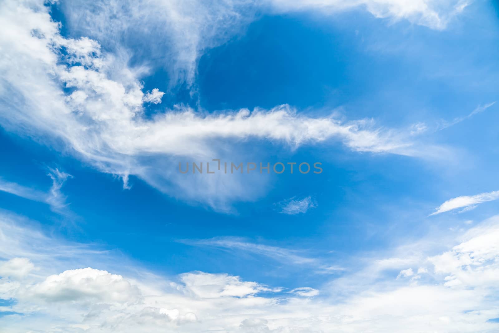 Background of clear blue sky with clouds.
