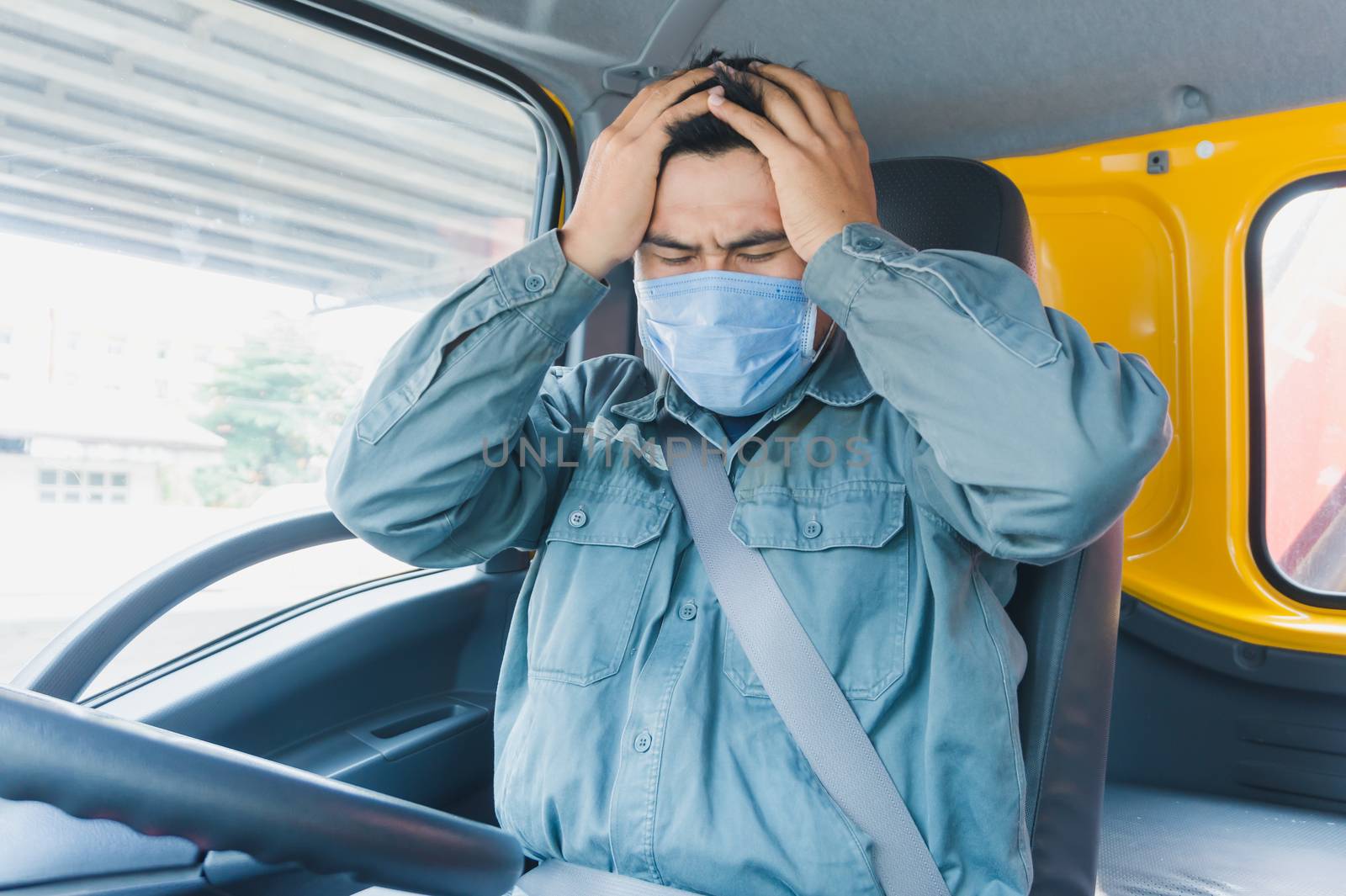 Close-up photos of Asian truck drivers wearing masks to protect against dust and the spread of the flu. Covid 19. Inside the car front