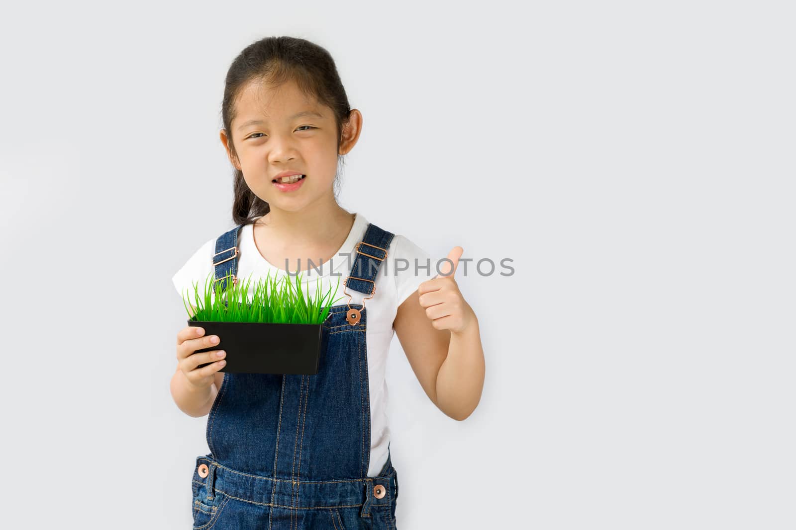 Studio shot of organic farming concept, Asian kid farmer, isolated on white background.