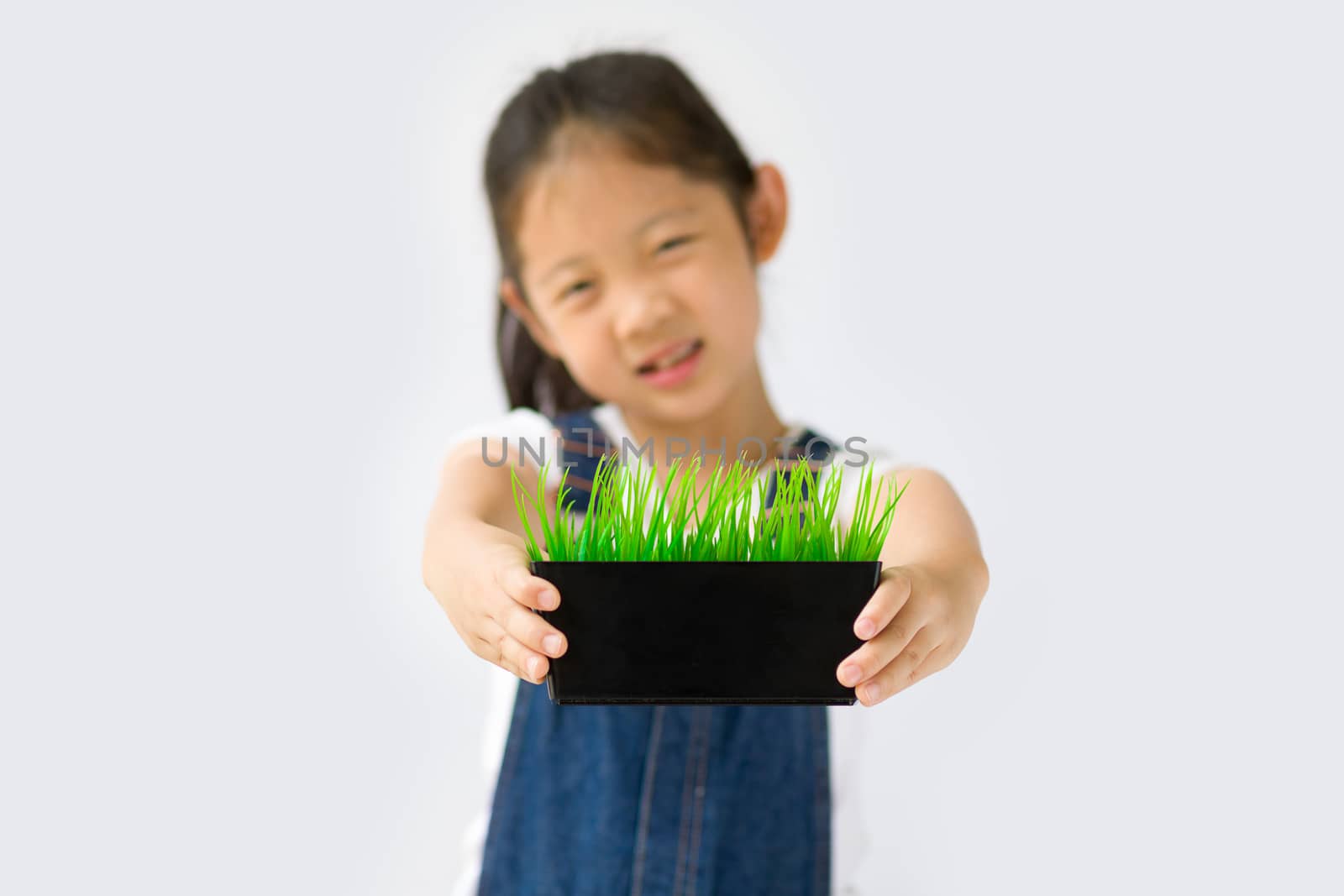 Studio shot of organic farming concept, Asian kid farmer, isolated on white background.