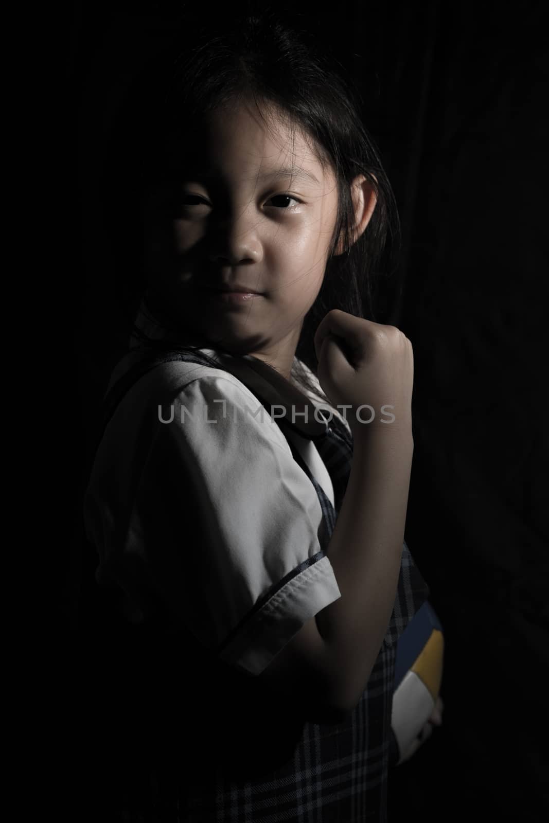 Portrait of determined Asian child for competition.