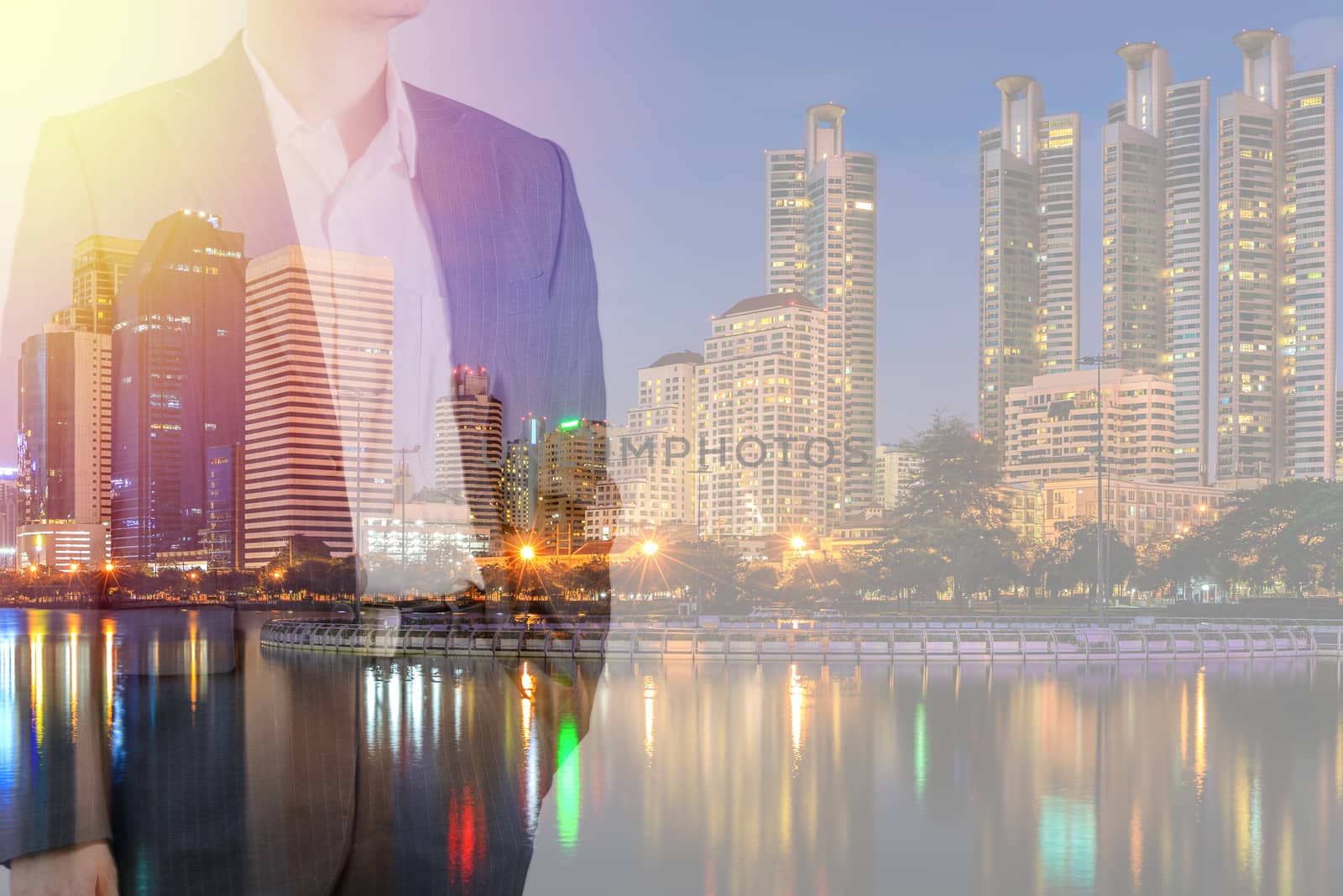 Business leadership concept shown by businessman in suit with urban city background in double exposure.