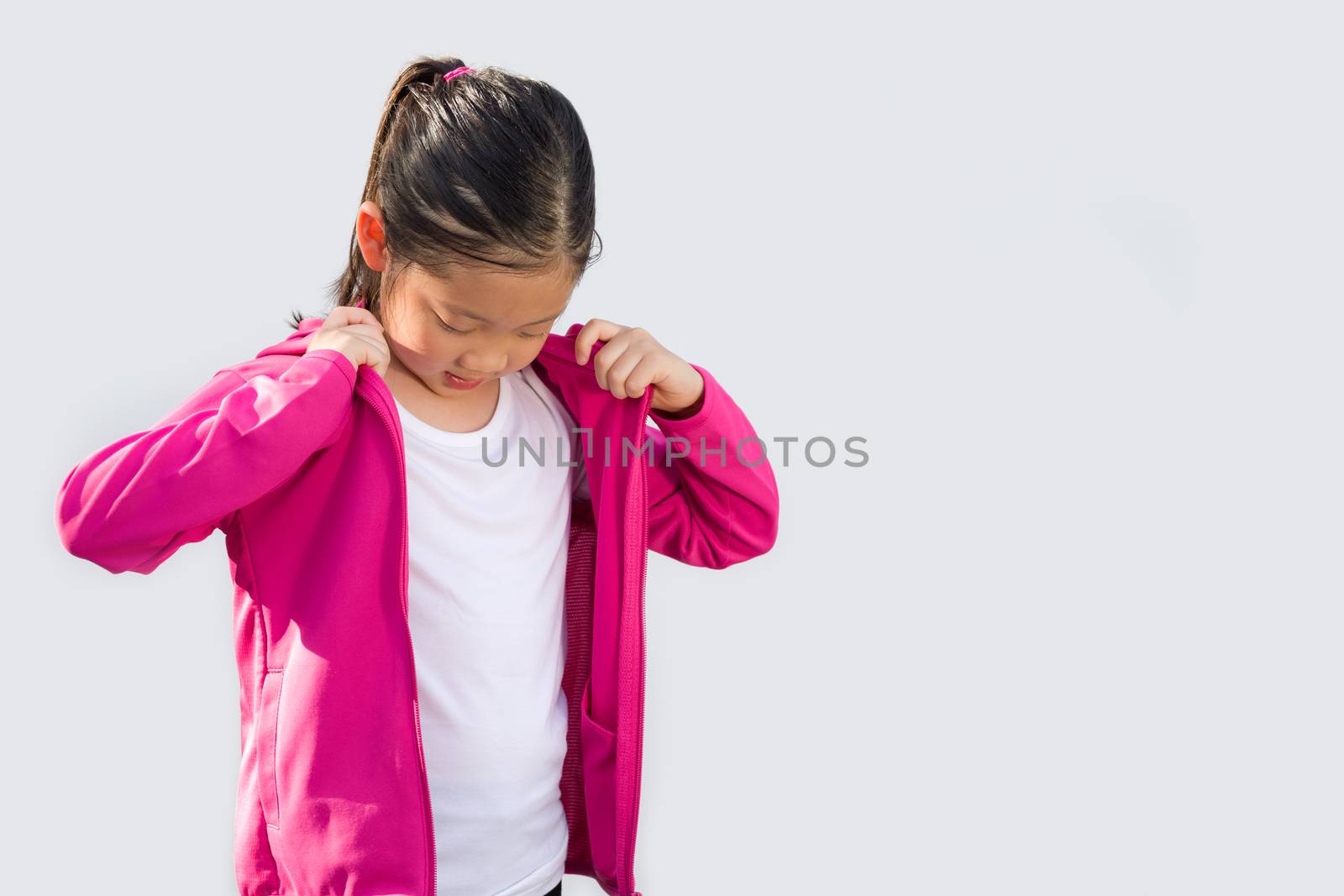 Sporty concept illustrated by studio shot of Asian child in sweater isolated on white background.