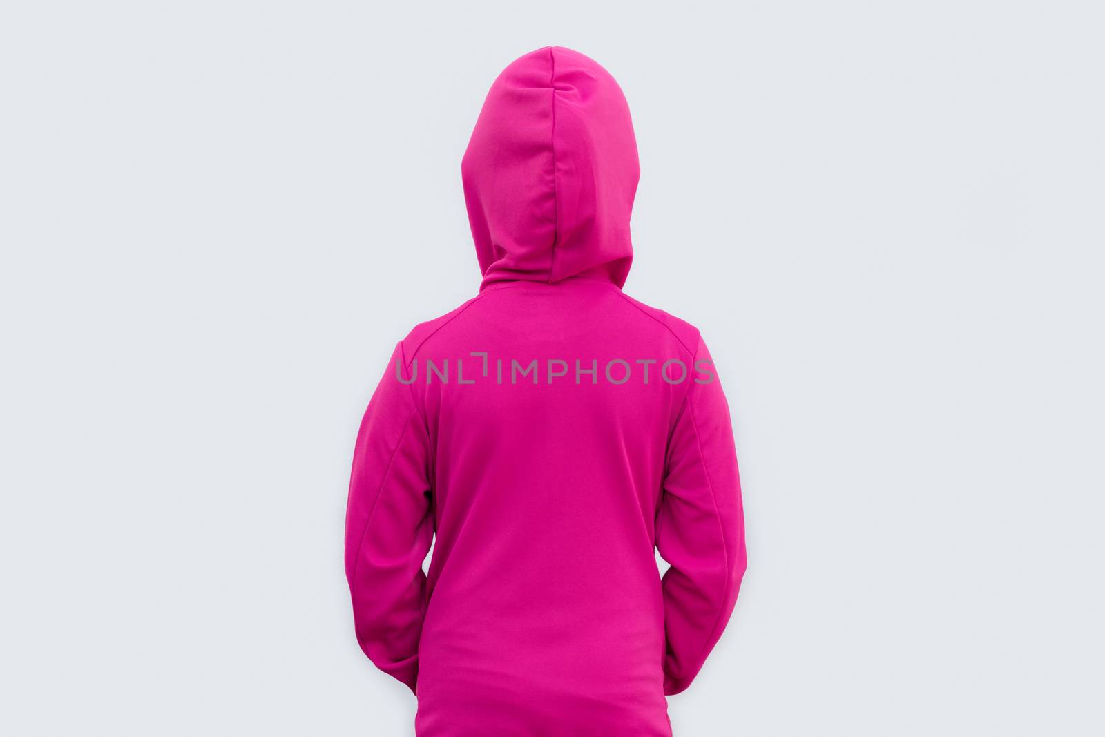 Studio shot of back of girl wearing sweater isolated on white background.