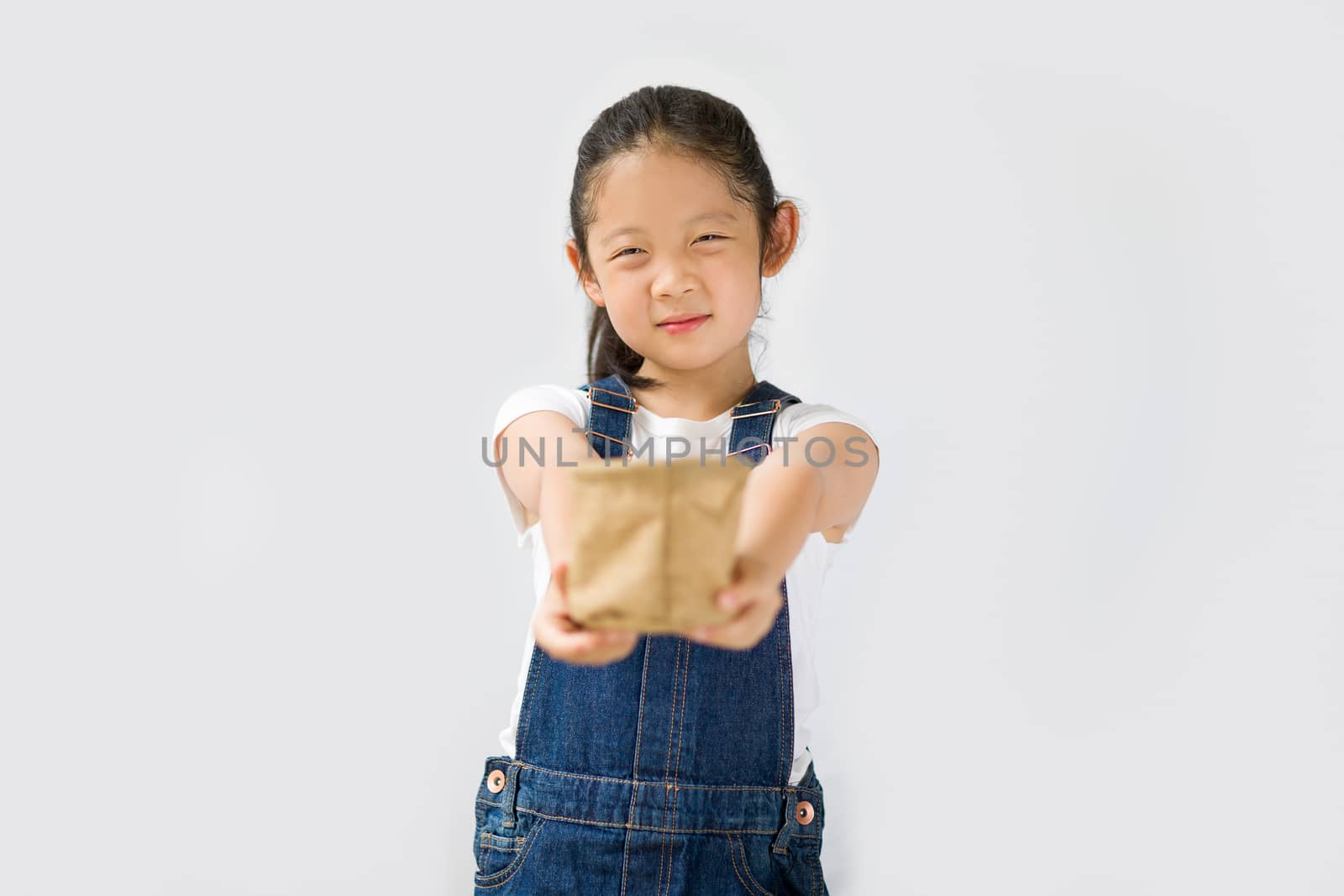 Studio shot of organic farming concept, Asian kid farmer, isolated on white background.