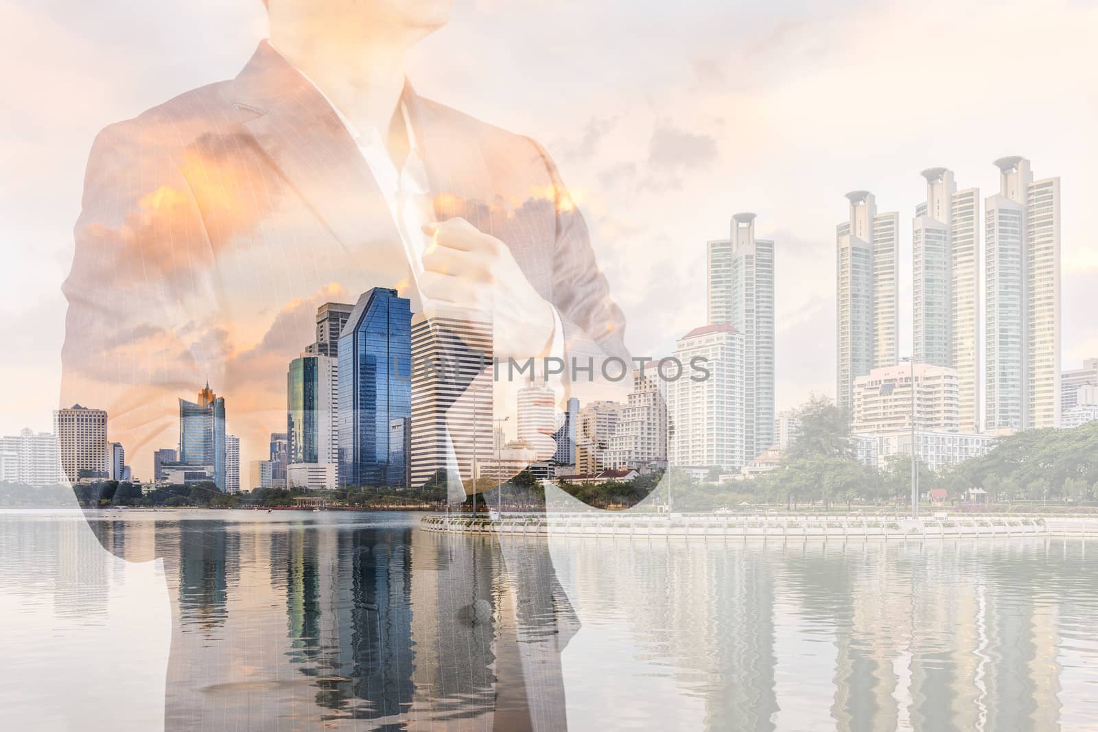Business leadership concept shown by double exposure of businessman in suit with urban city background.