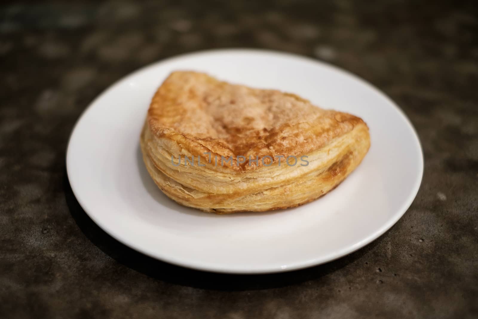 Baked apple puff turnover pastry in dish.