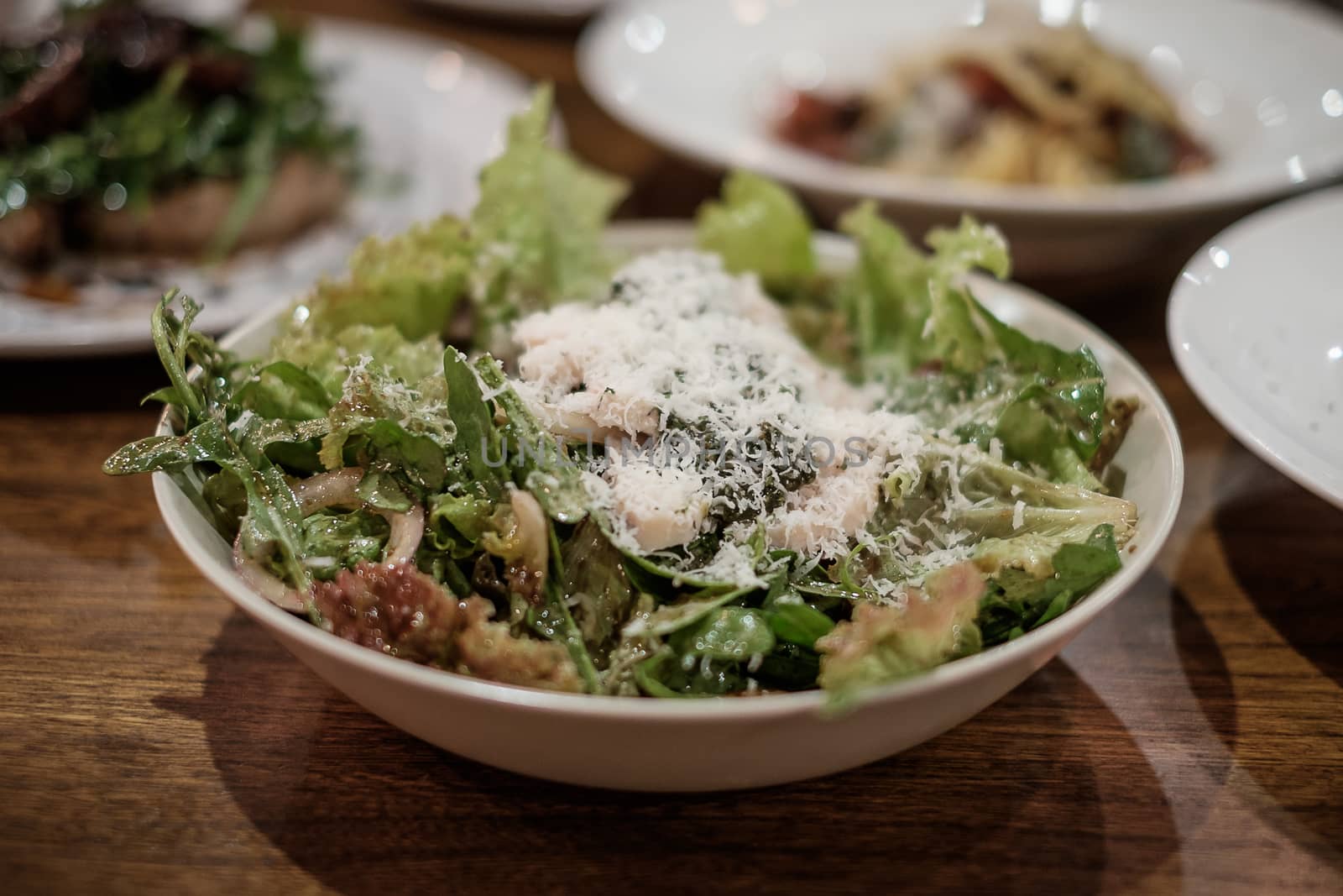 Caesar salad with chicken in bowl.