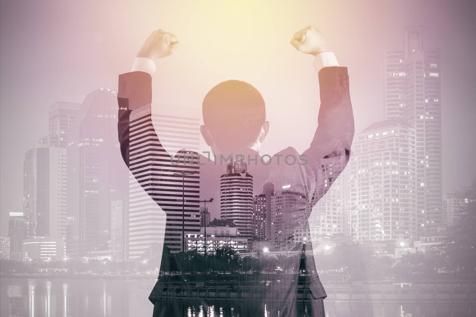Business success concept shown by double exposure of business in suit with urban city background.
