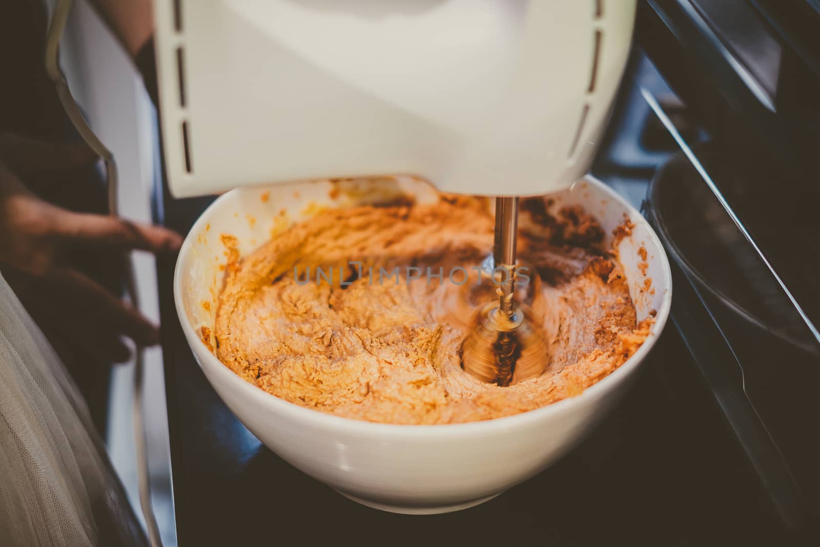 Mixer is mixing cookie ingredients in bowl, vintage look.
