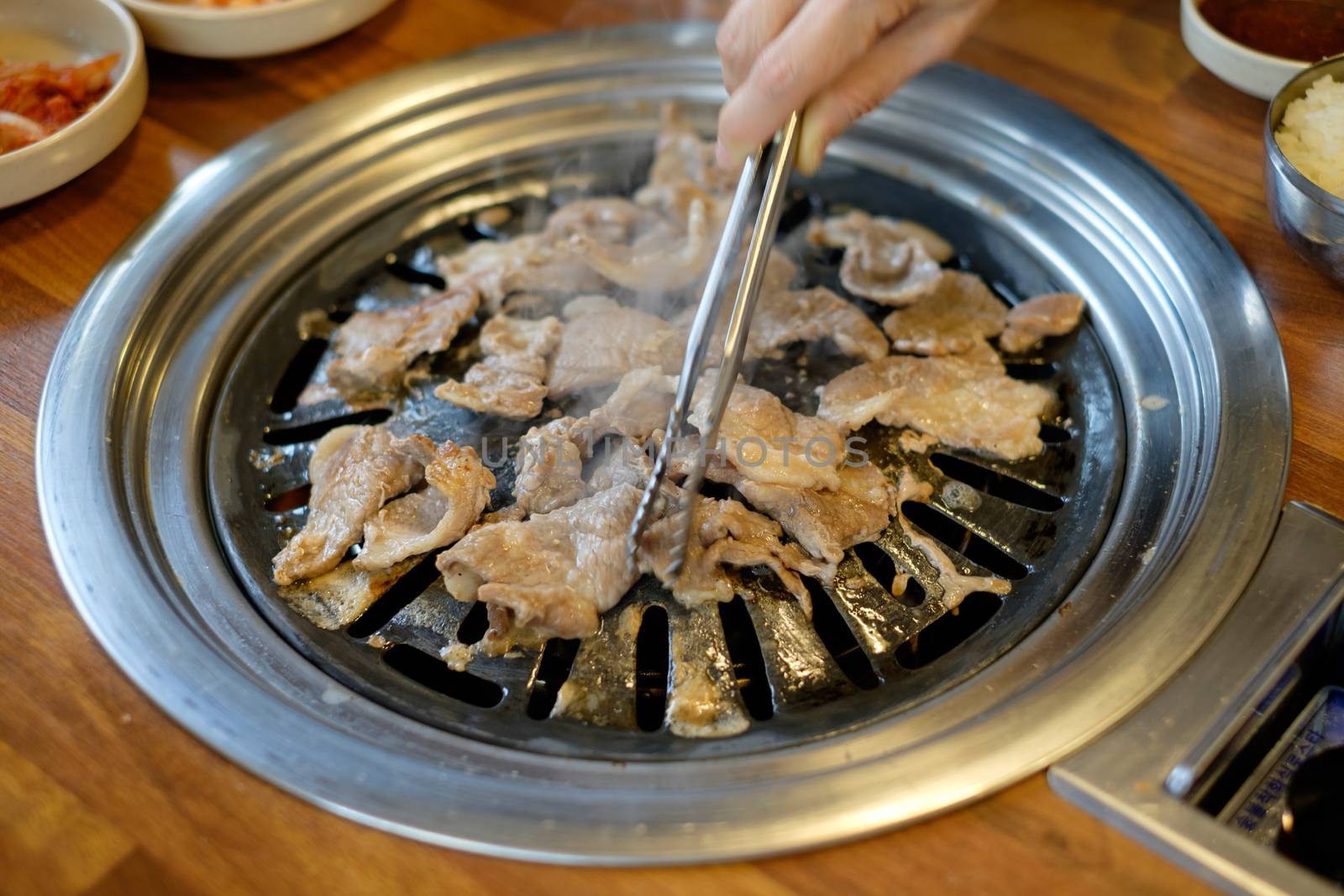 Korean BBQ grilled pork and beef cooking.