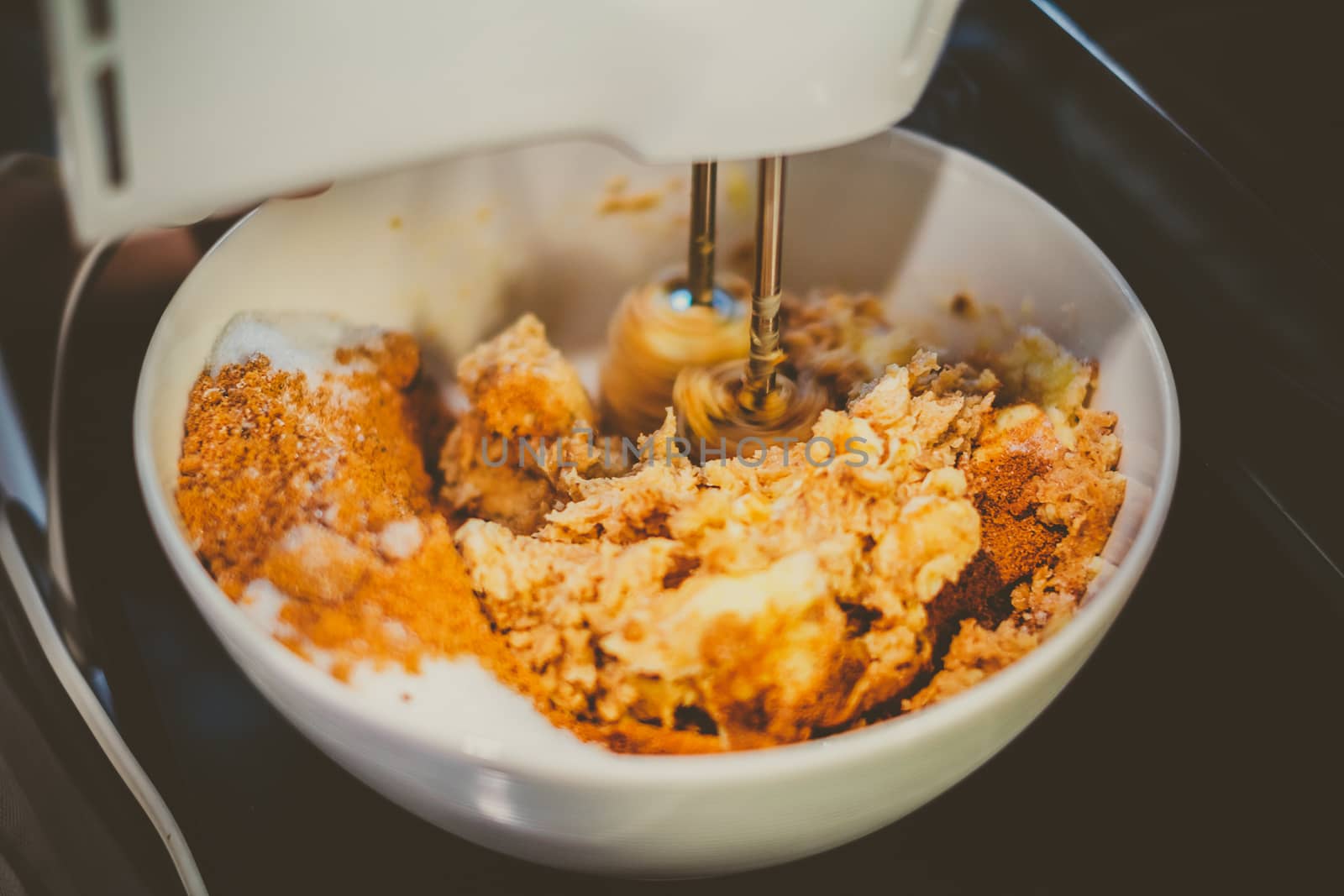 Mixer is mixing cookie ingredients in bowl, vintage look.