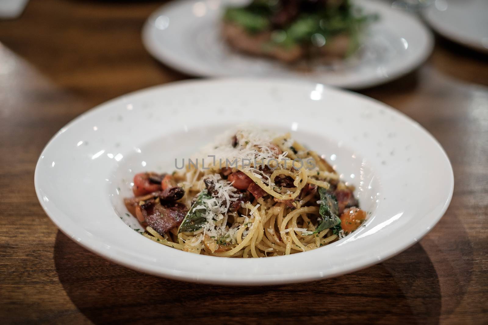 Spaghetti with olive oil, dry chili, and bacon, traditional Italian style.