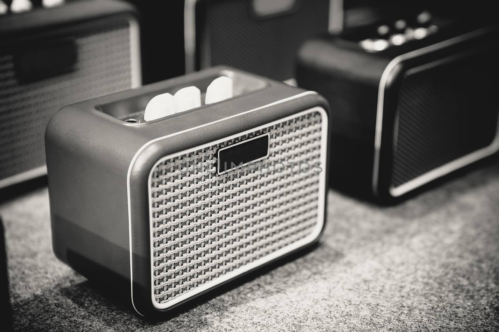 Mini speaker for music and audio system in black and white.