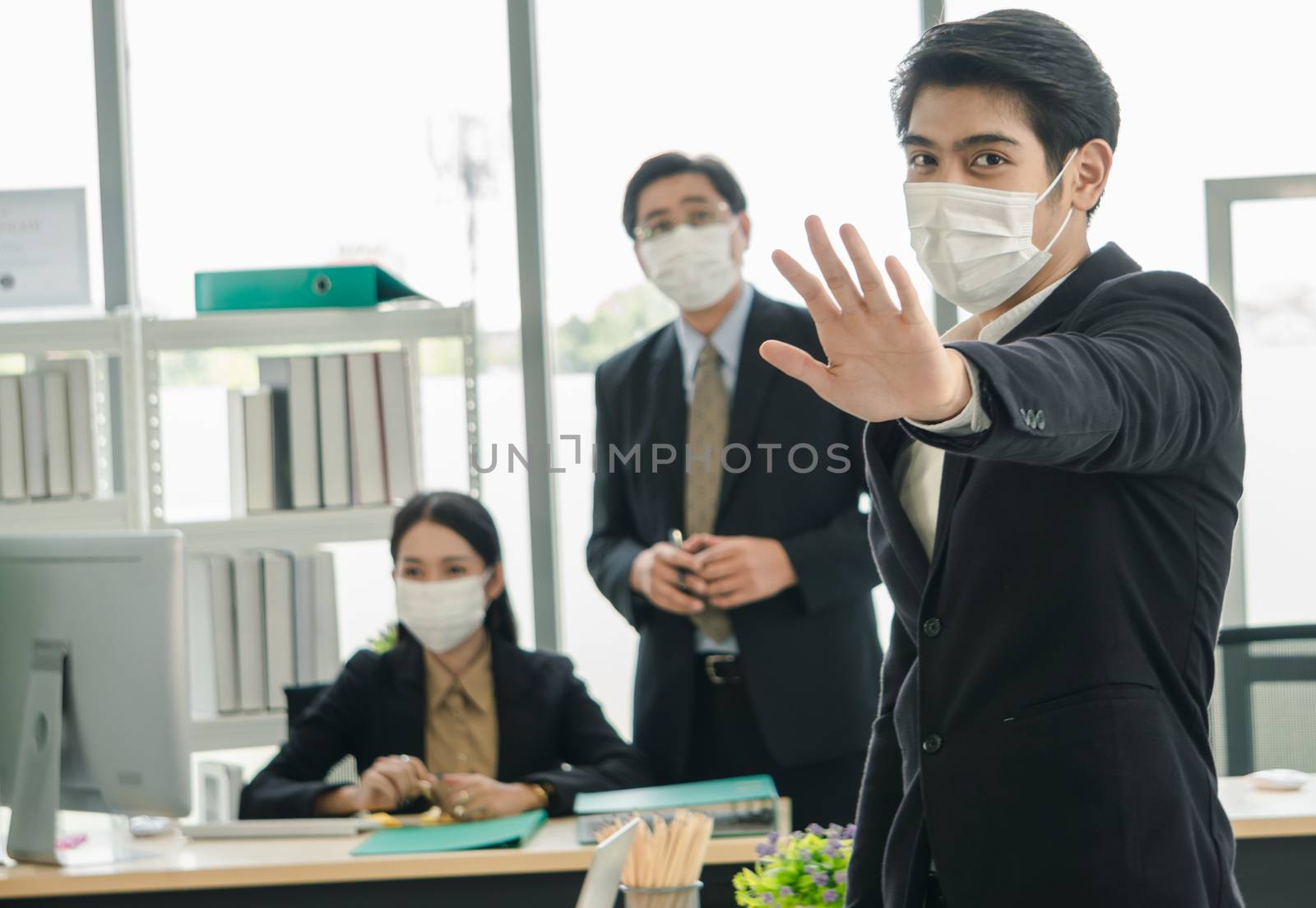 Stop Covid-19-Concept. A team of Asian businessmen wear masks to protect and prepare to fight the pandemic virus worldwide.