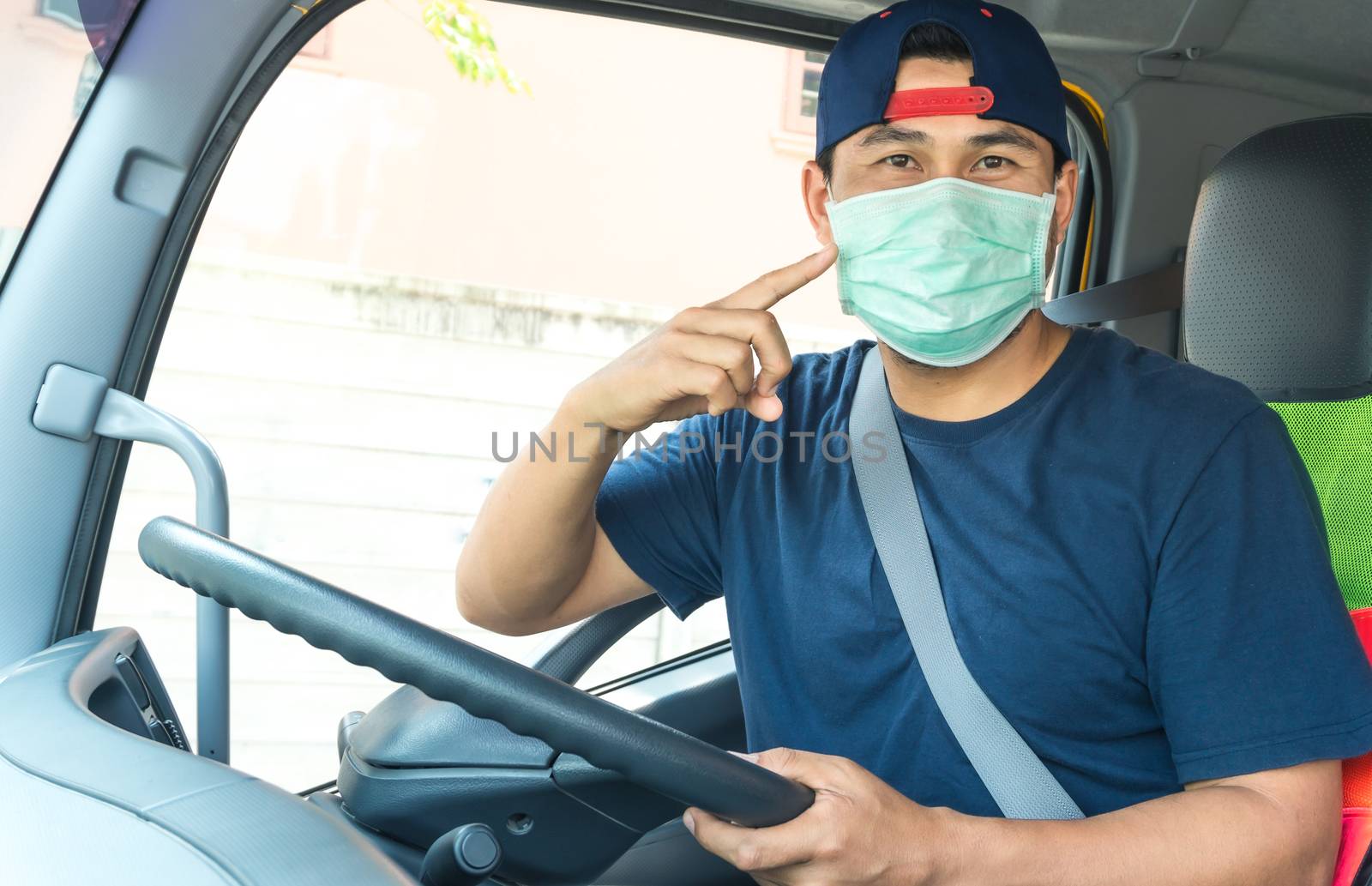 Close-up photos of Asian truck drivers wearing masks to protect against dust and the spread of the flu. Covid 19. Inside the car front