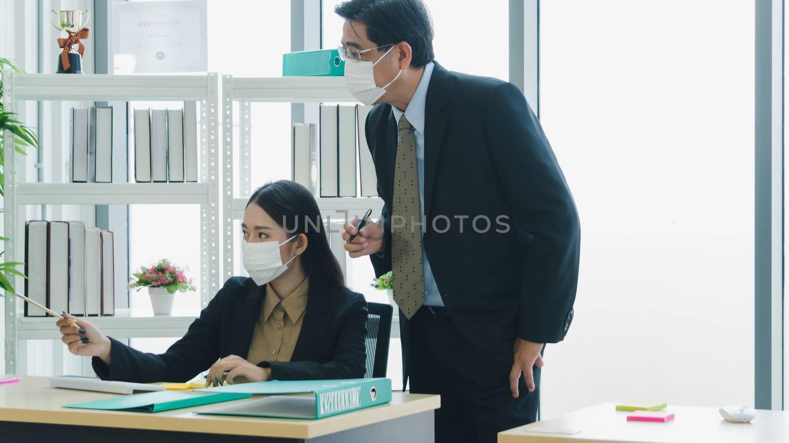 Business people wear protective masks to work by nuad338