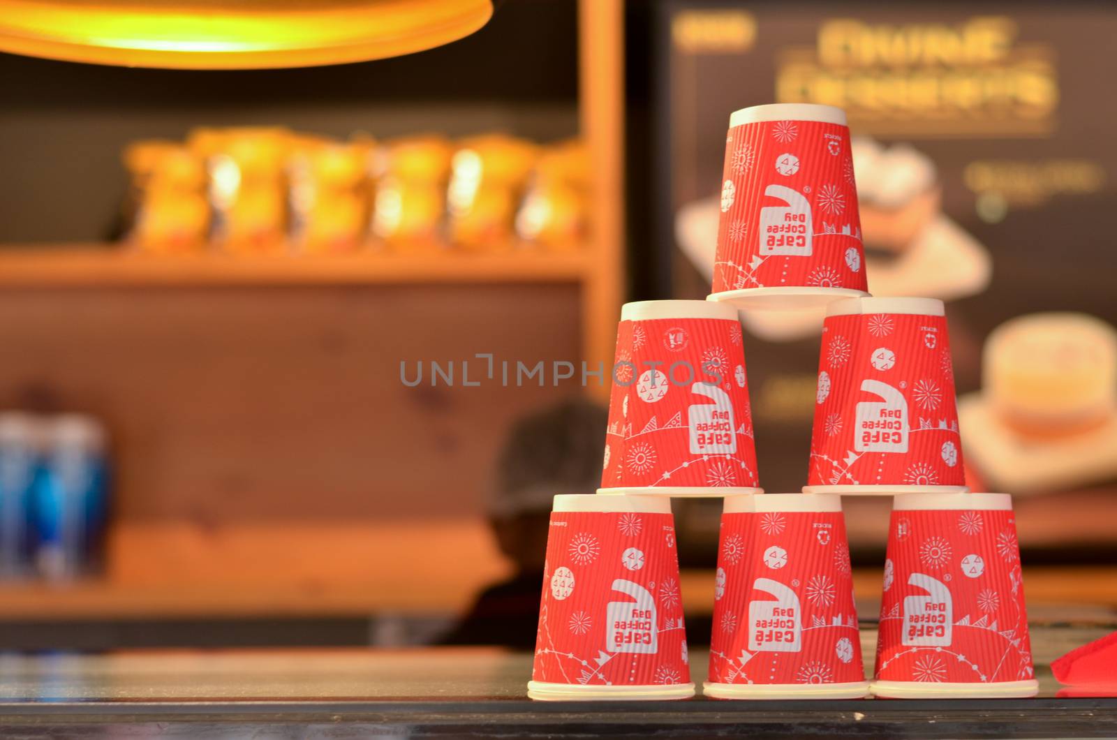 New Delhi, India, 2020. Red disposable cups with the CCD (Cafe Coffee Day) logo stacked on top of each other making pyramids on the counter for display and decor at the coffee shop.