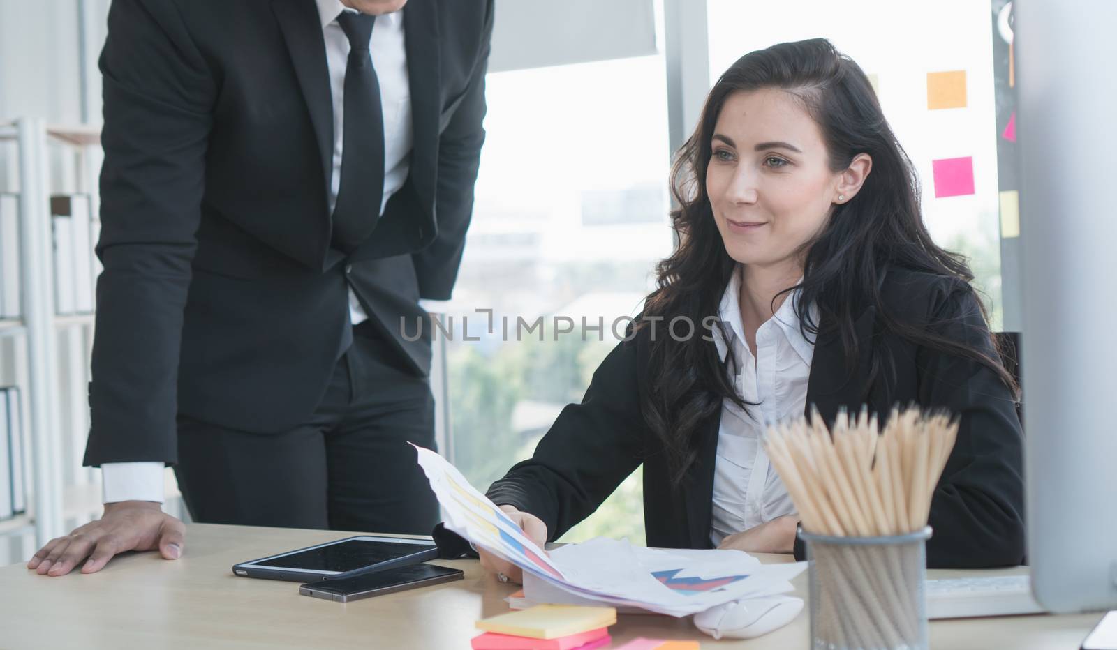 Caucasian business men and women working together happily at the office. They are meeting with a video call. To trade with business partners