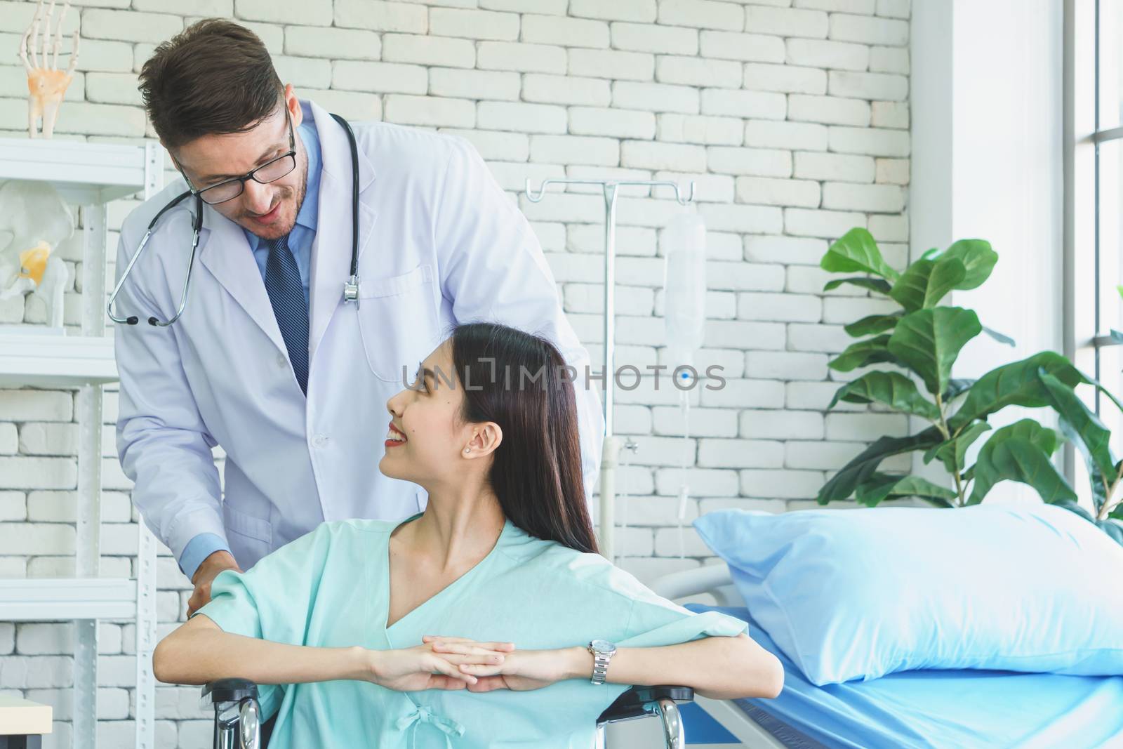 Photos of a male doctor taking care of a female patient and providing health care advice In the patient room of the hospital