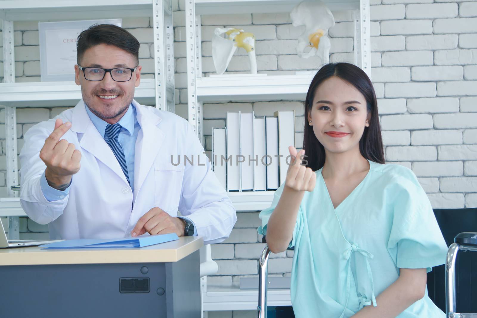 Photos of a male doctor taking care of a female patient and providing health care advice In the patient room of the hospital