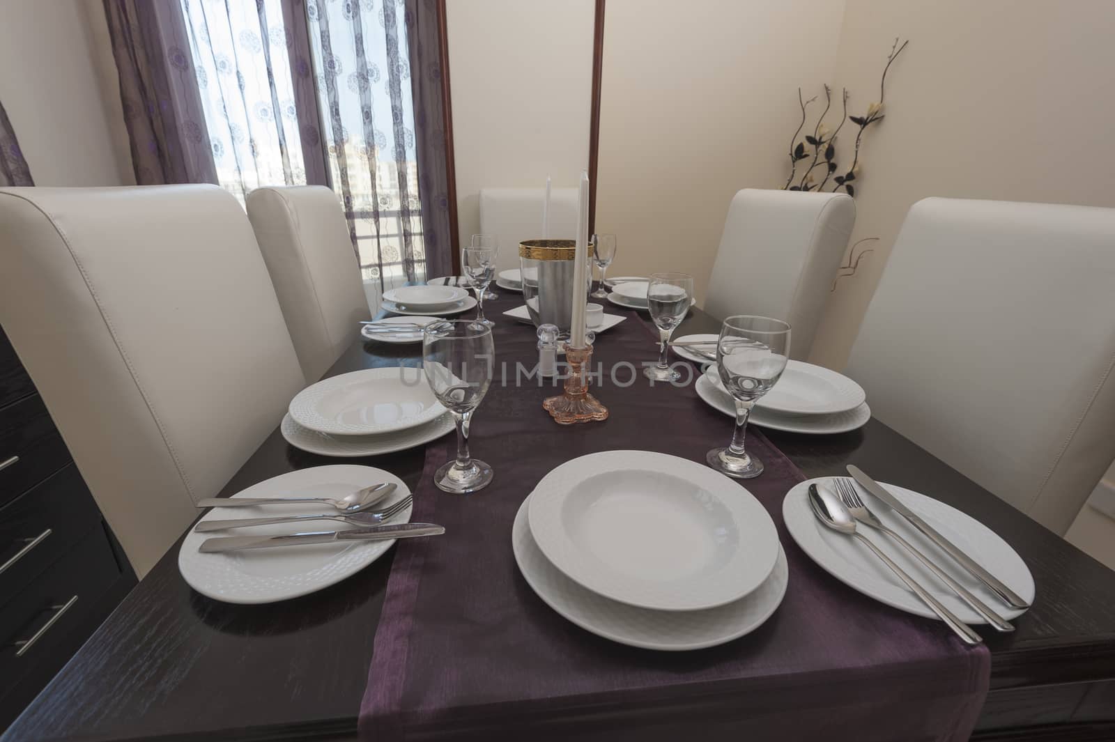 Dining room with table and settings in a luxury apartment