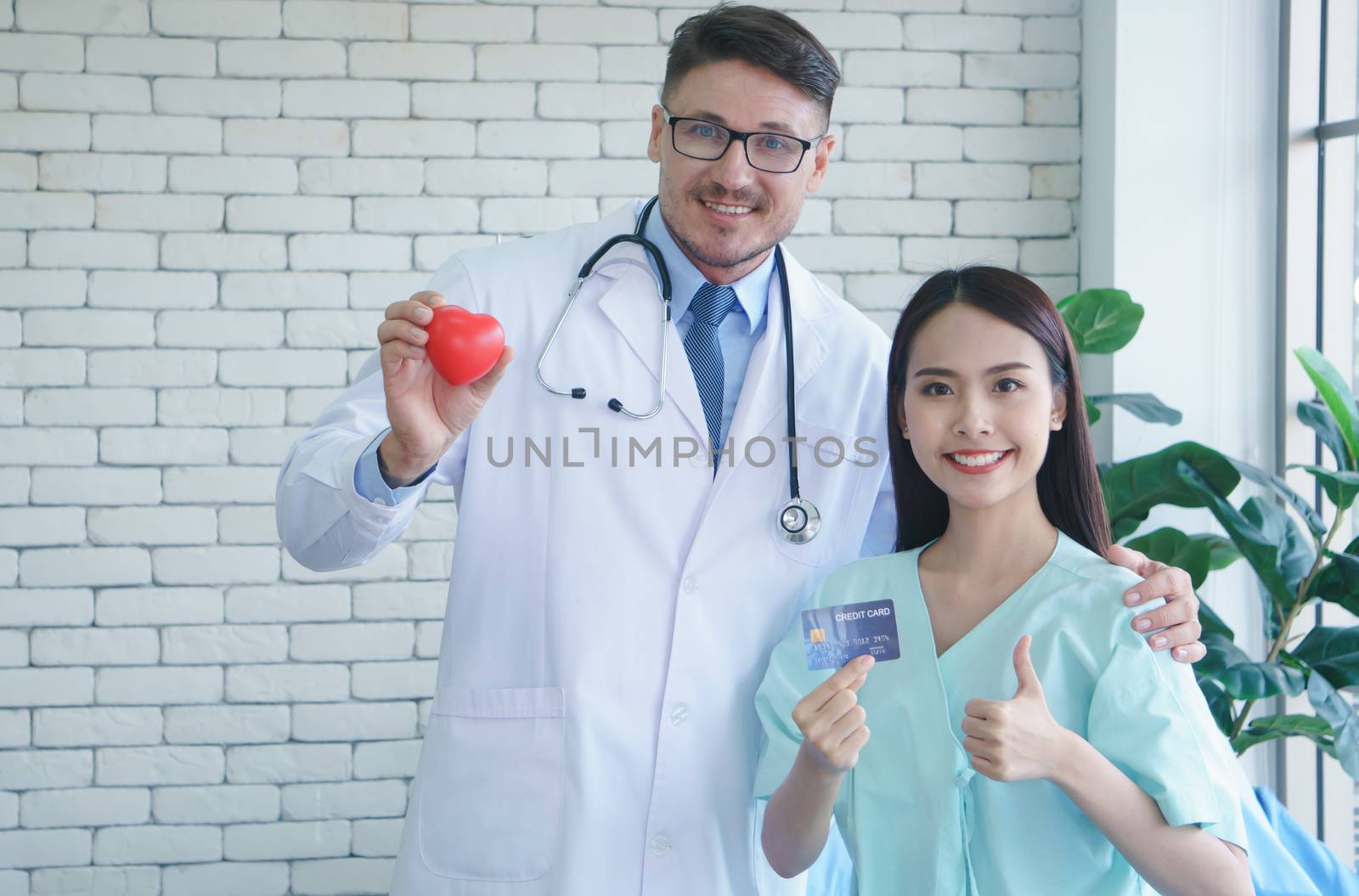 Photos of a male doctor taking care of a female patient and providing health care advice In the patient room of the hospital