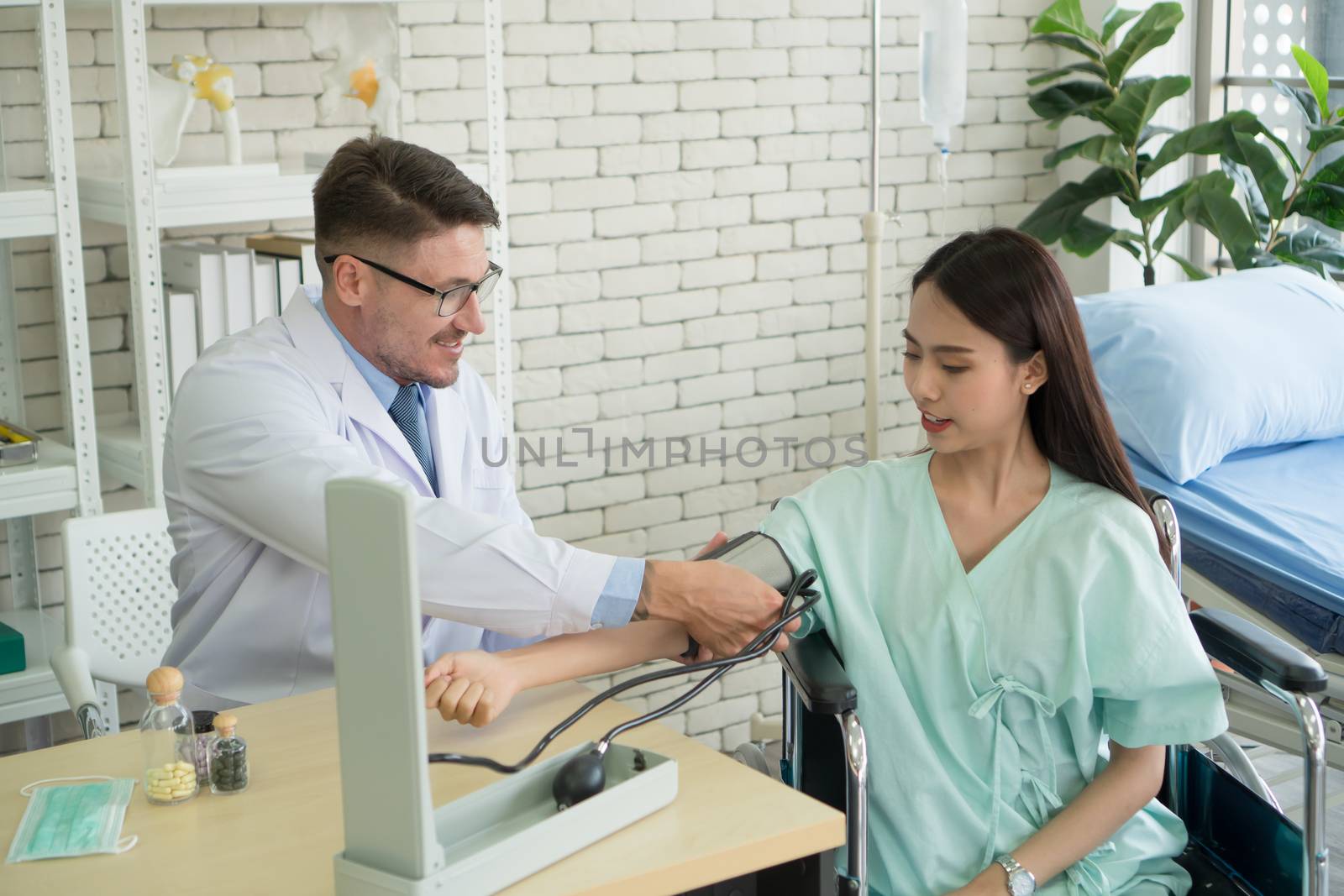 Photos of a male doctor taking care of a female patient and providing health care advice In the patient room of the hospital