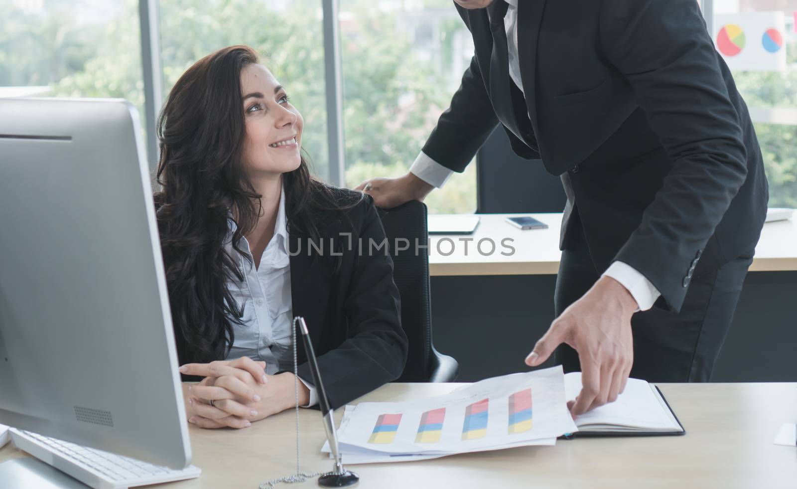 Caucasian business men and women working together happily at the office. They are meeting with a video call. To trade with business partners