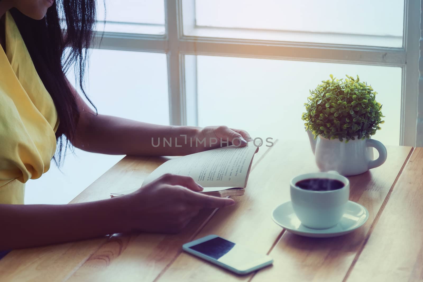 Beautiful girl sitting by reading a book by the window in a coff by numberone9018