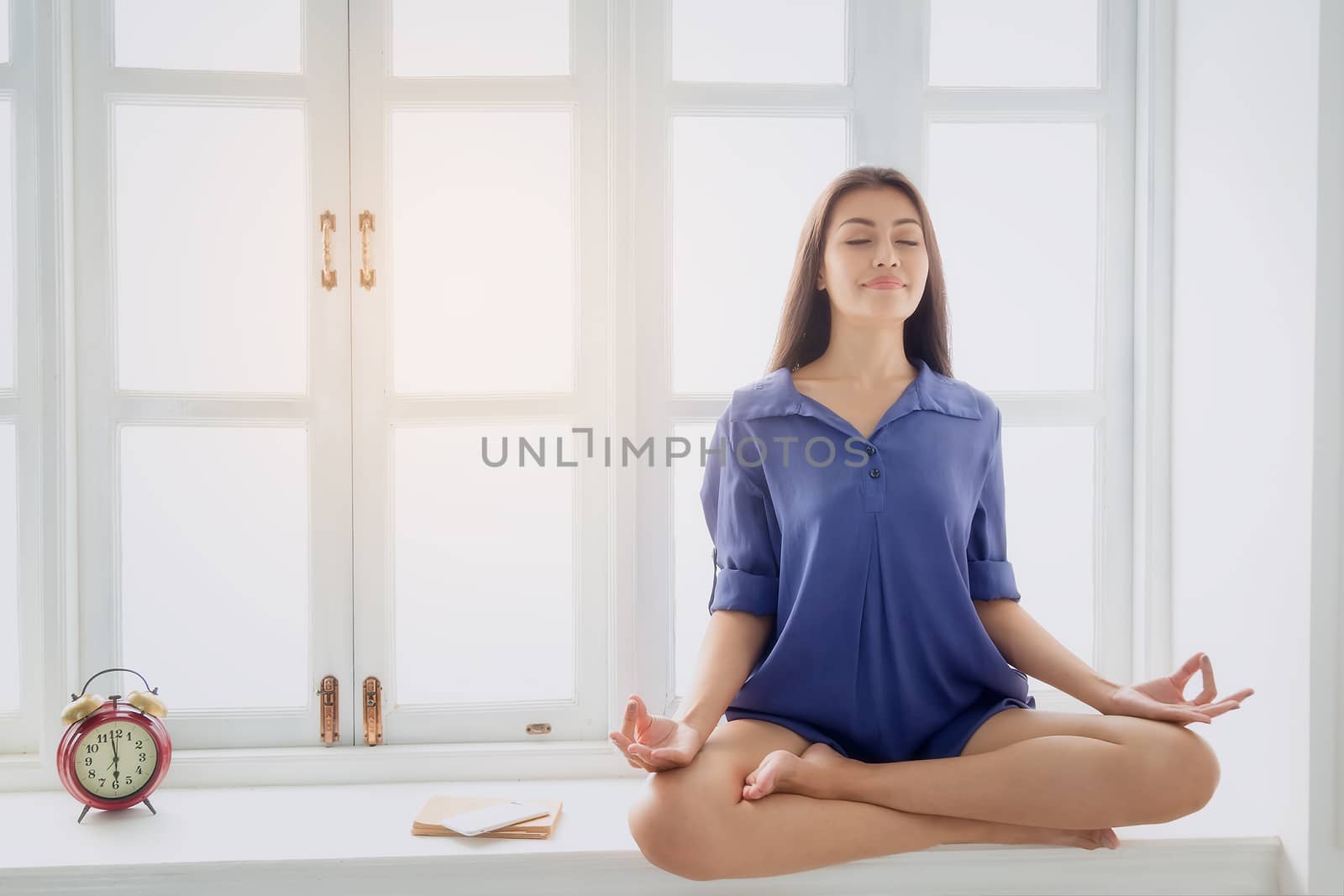 Young woman exercises with yoga in the morning after waking up. Health care concept