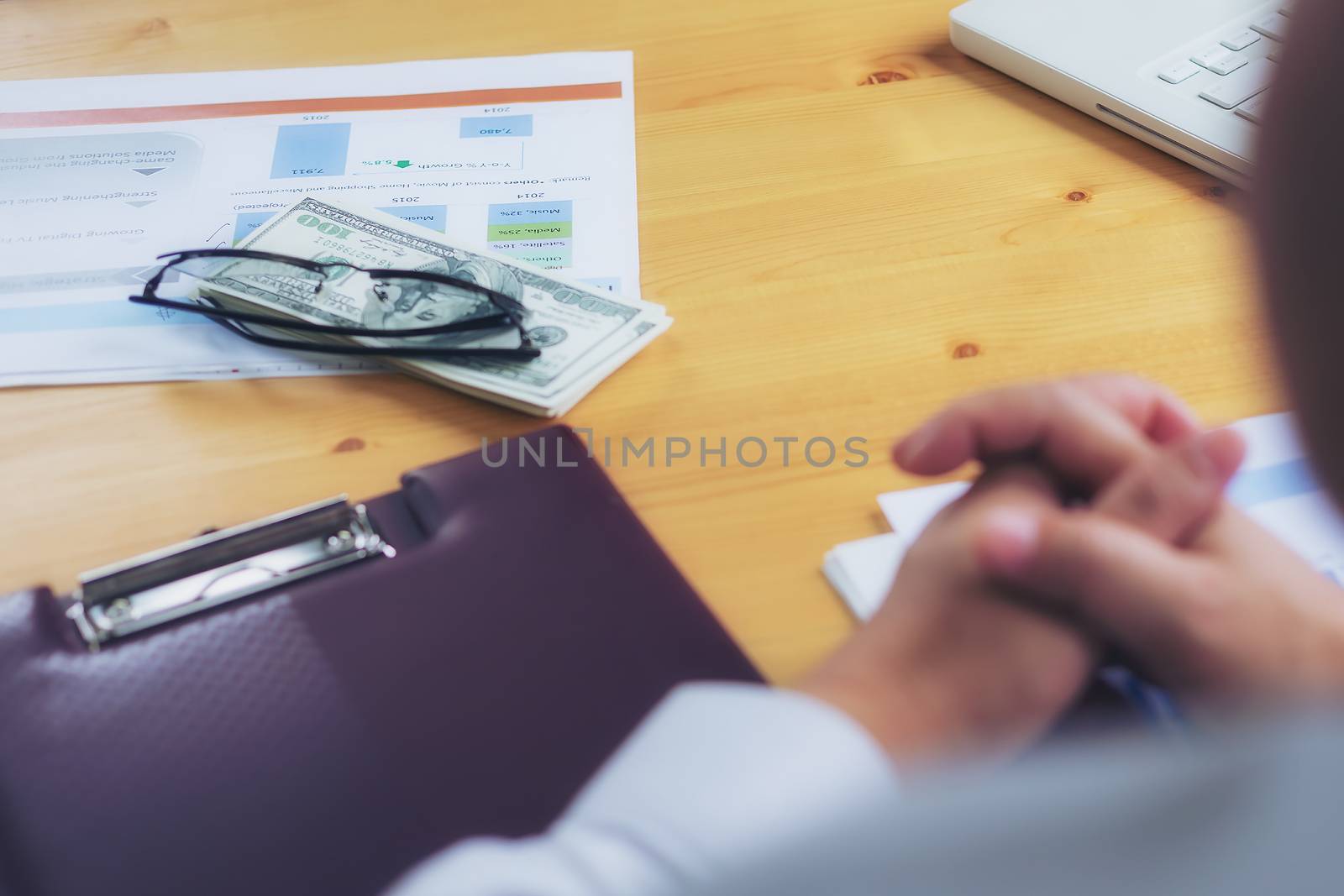 A handsome businessman waiting for a signed and promised money in a transaction.