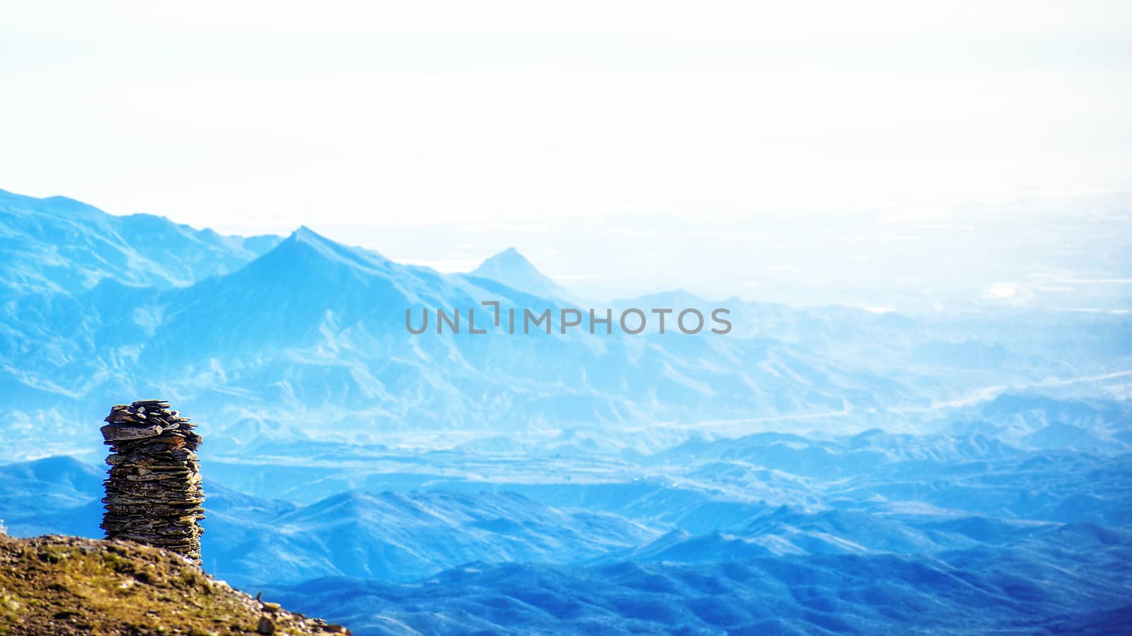 Zen balanced stones stack in high mountains against idyllic landscape. Blue mountains in Calar Alto Observatory, Almeria, Spain