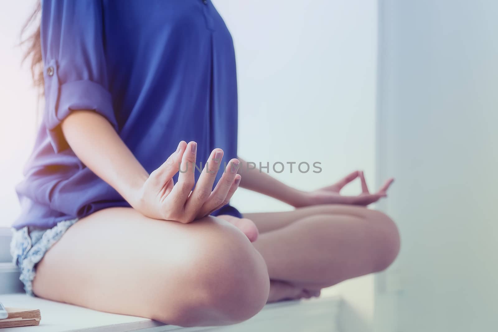 Young woman exercises with yoga in the morning after waking up. Health care concept
