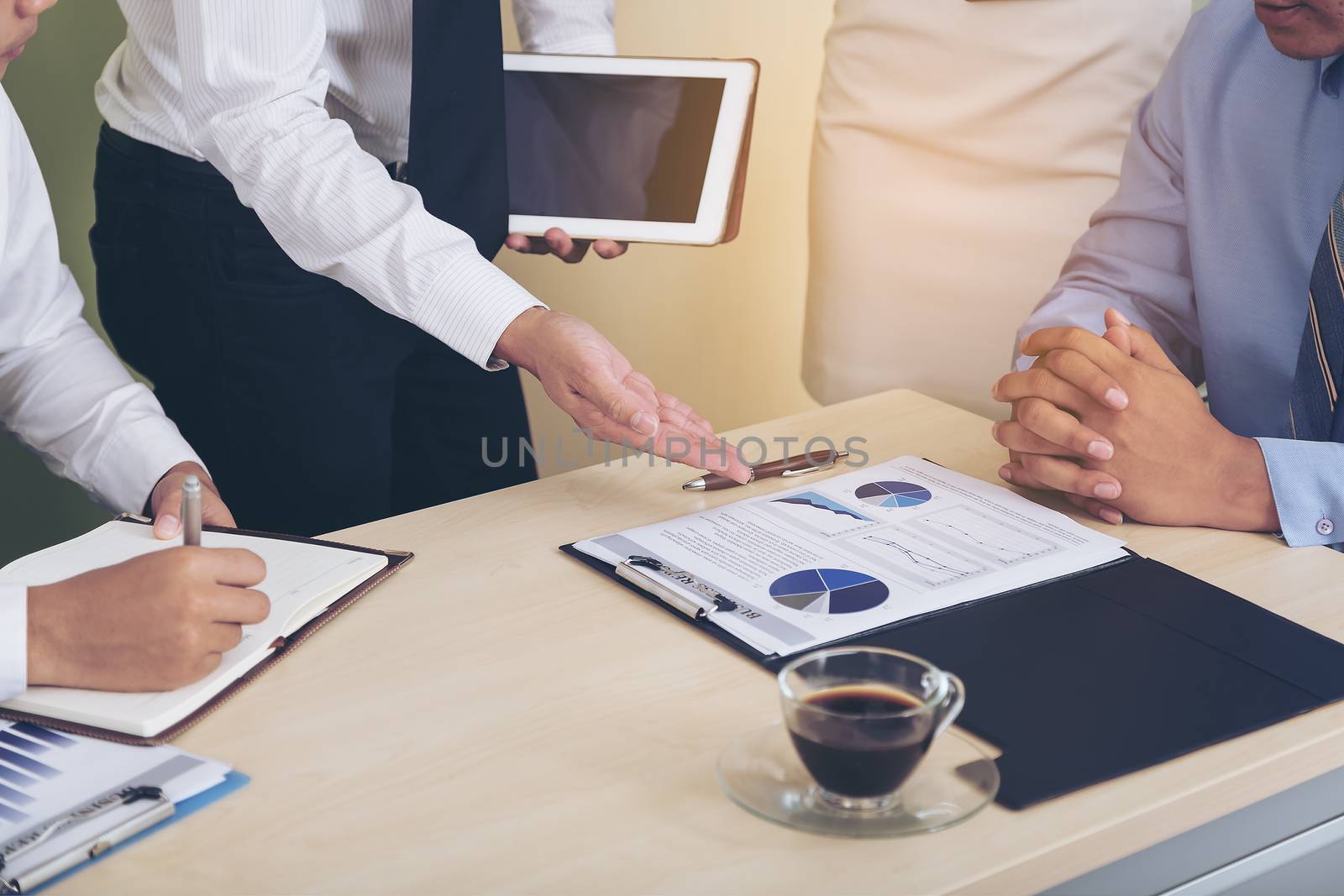 Portrait of investment agent consulting with his client while sitting at office