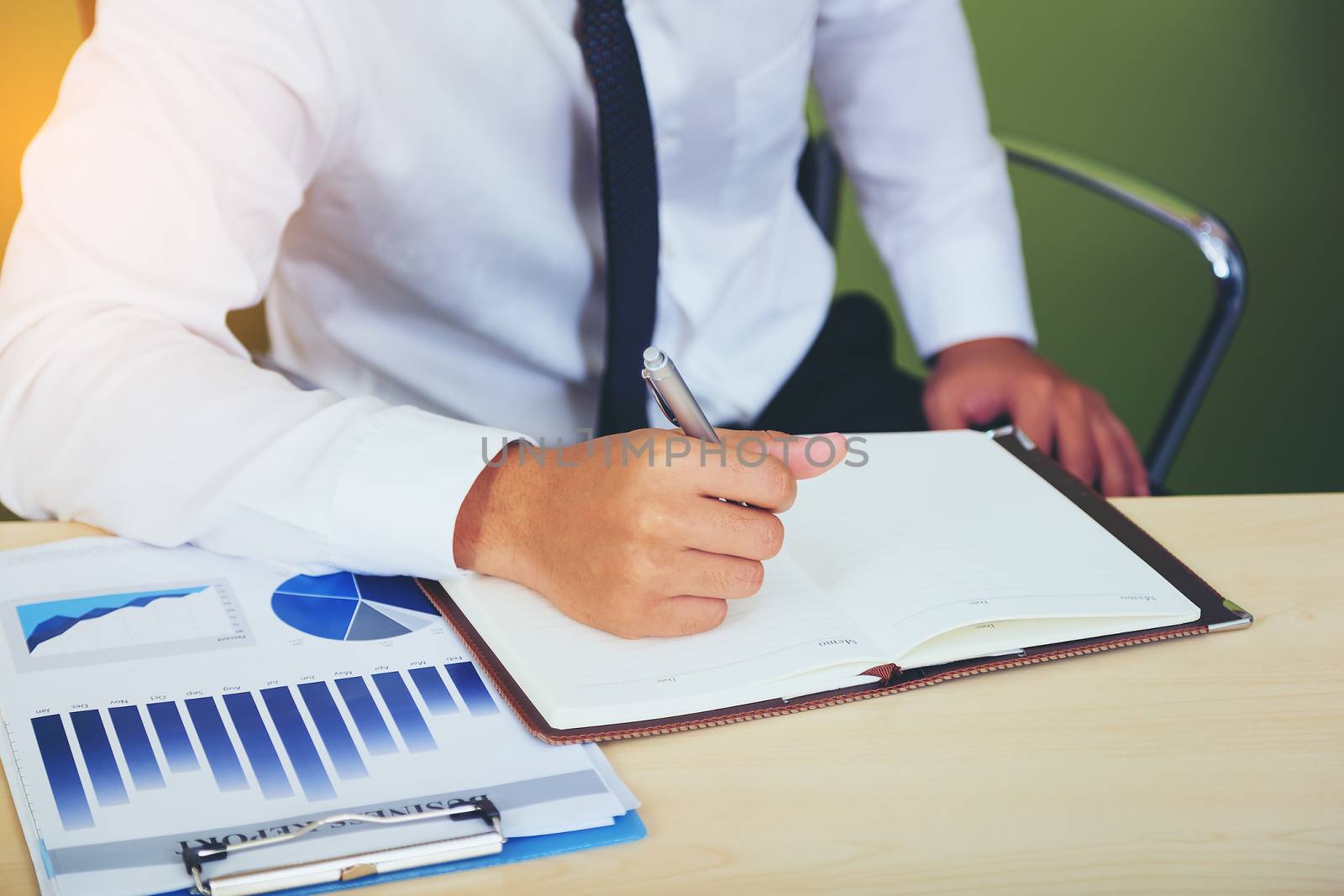 Portrait of investment agent consulting with his client while sitting at office