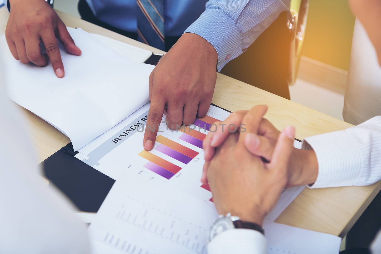 Portrait of investment agent consulting with his client while sitting at office