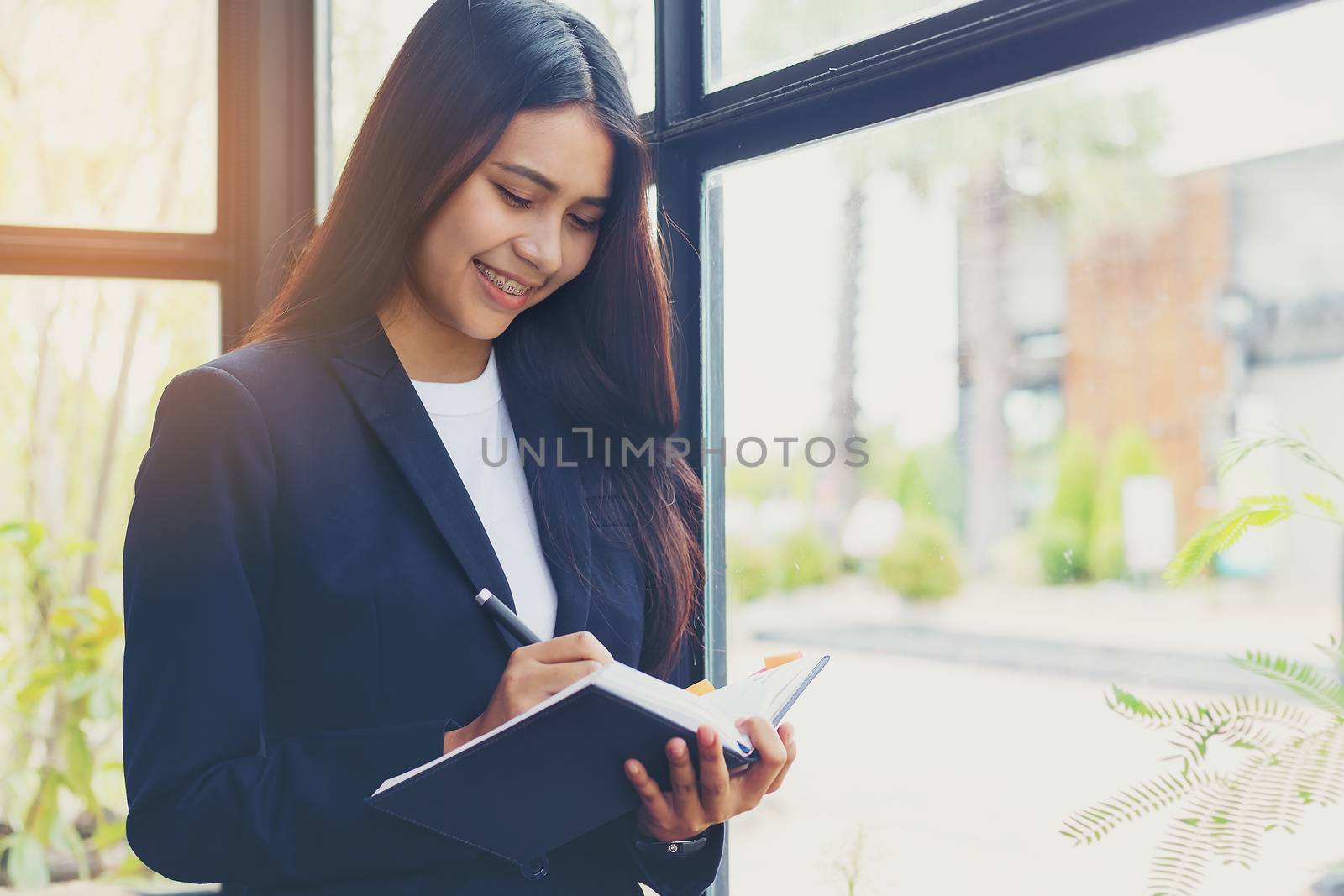 Employees who work online Is sitting happily in a cafe by numberone9018