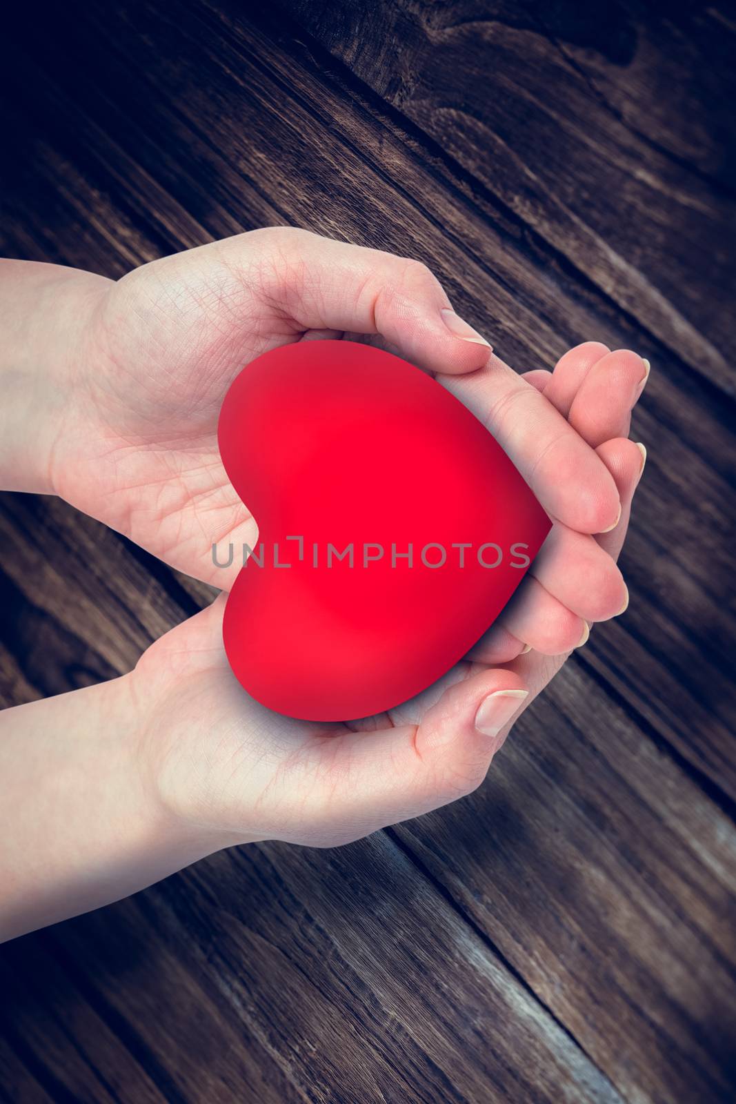 Composite image of hand showing heart by Wavebreakmedia