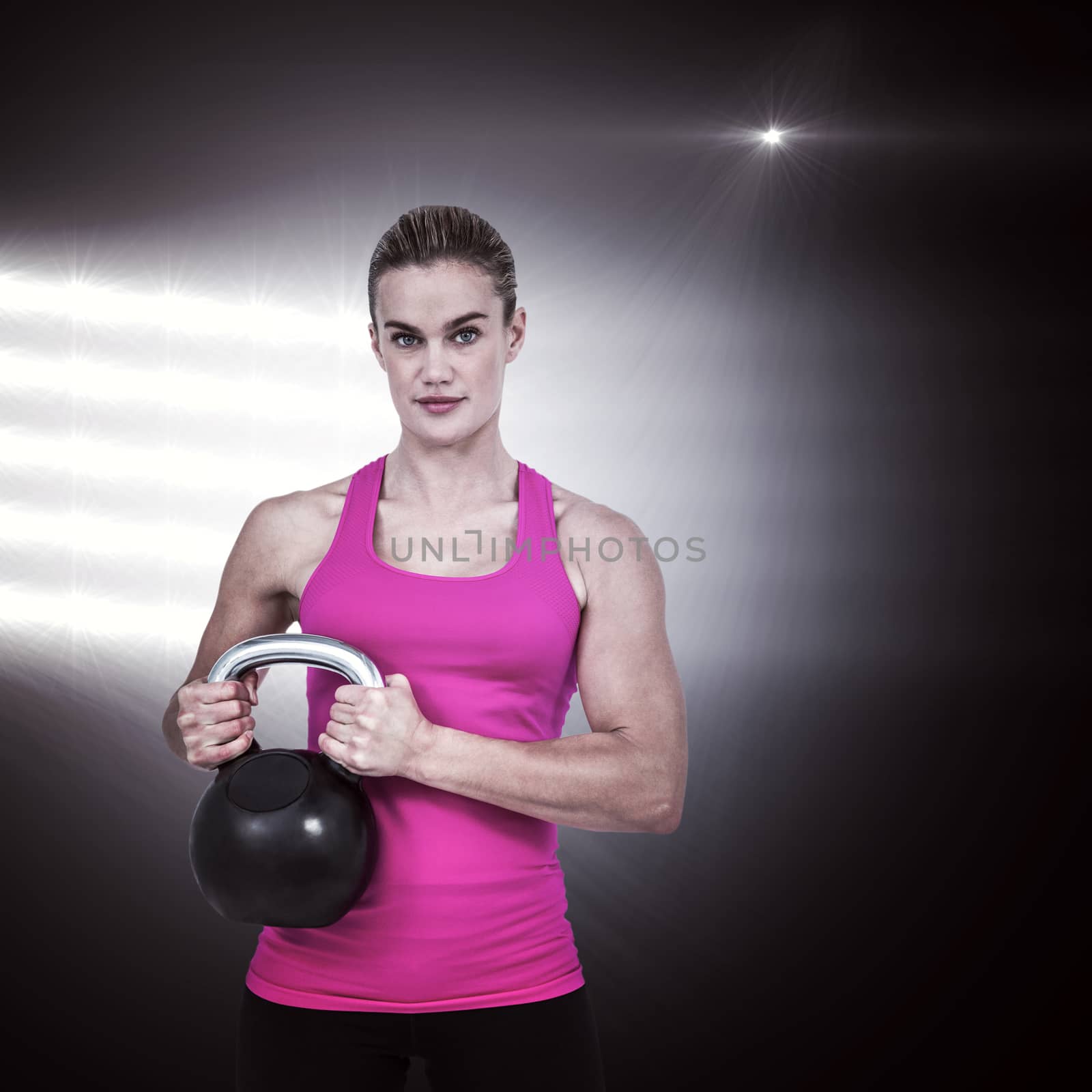 Composite image of muscular woman exercising with kettlebell by Wavebreakmedia