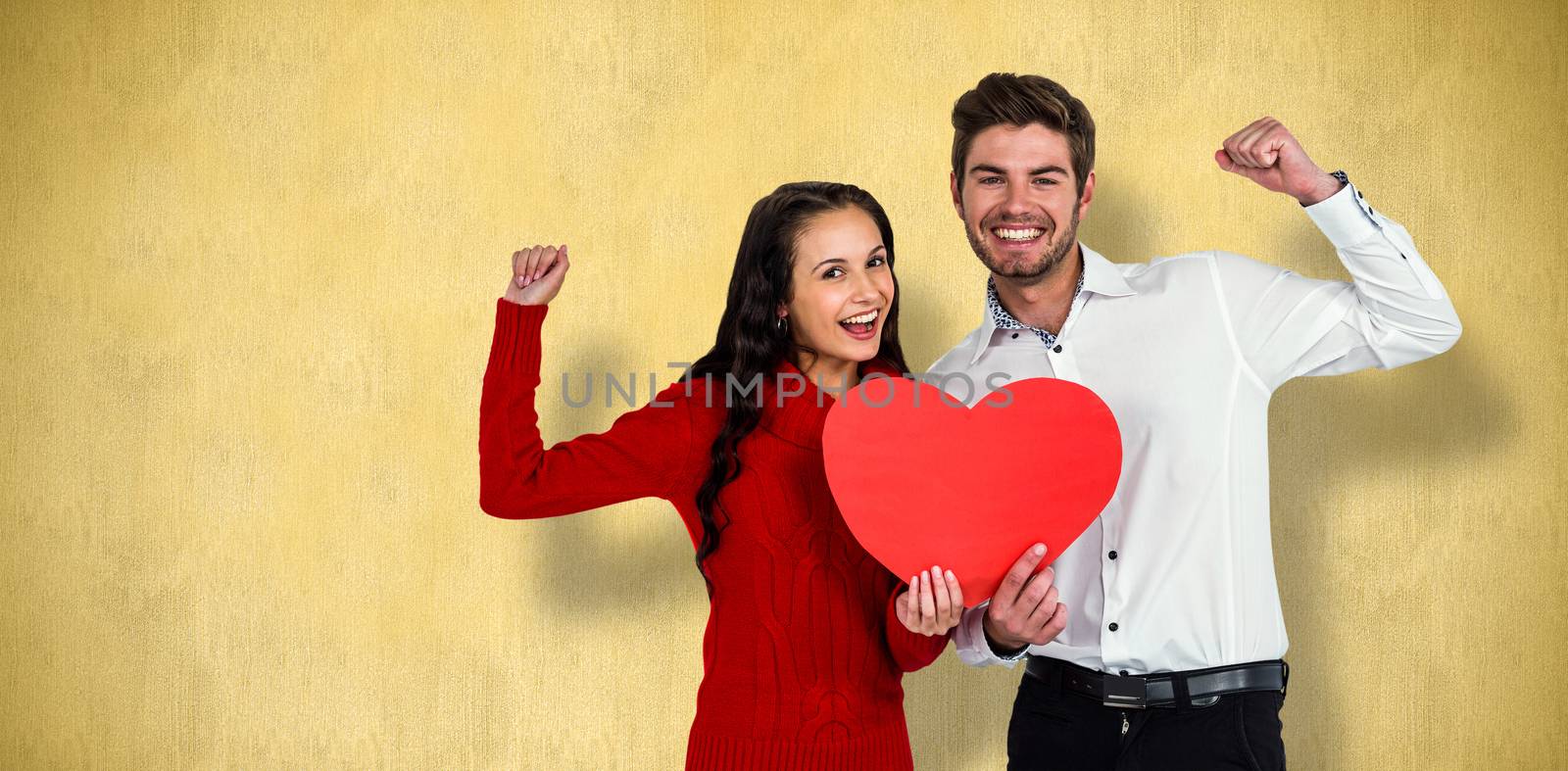 Cheerful couple holding paper heart against orange background 