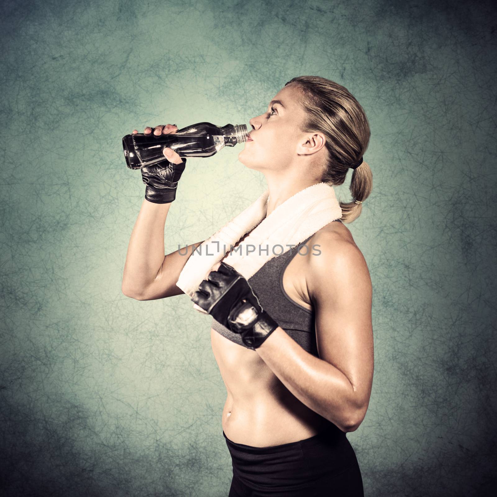 Composite image of muscular woman drinking water  by Wavebreakmedia