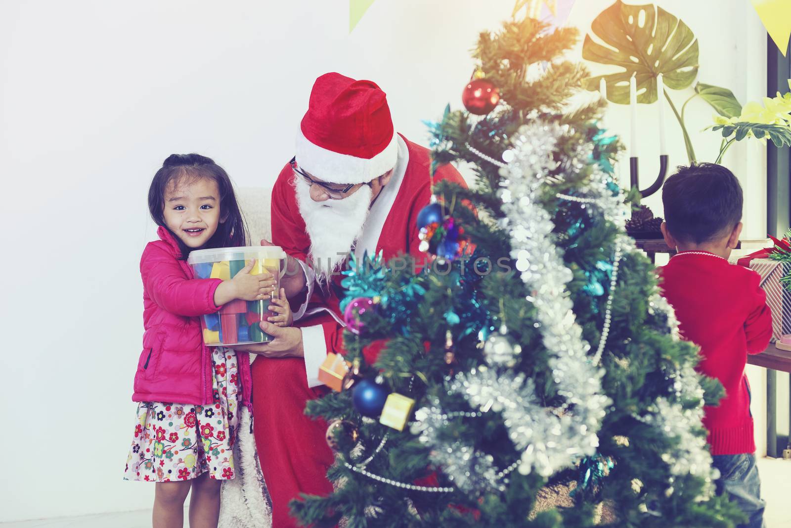 Father and son help to decorate the Christmas tree.