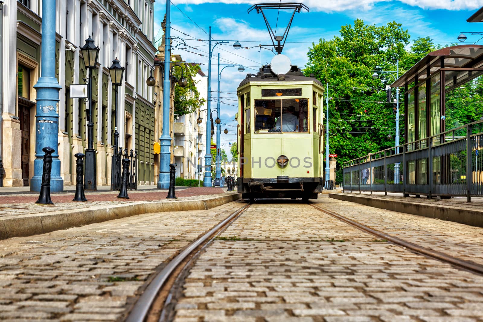 Historic tram line in the city of Wrotclaw. light green wagon ready for shipment