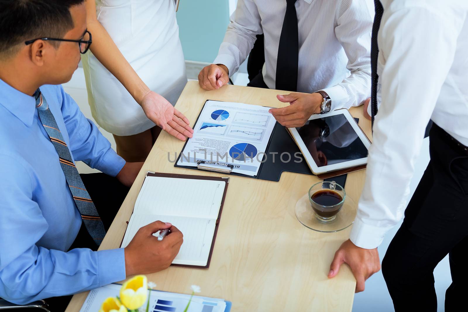 Portrait of investment agent consulting with his client while sitting at office