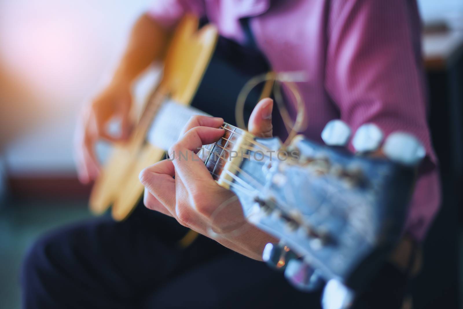 The musician is enjoying the guitar. Focus on fingers by numberone9018