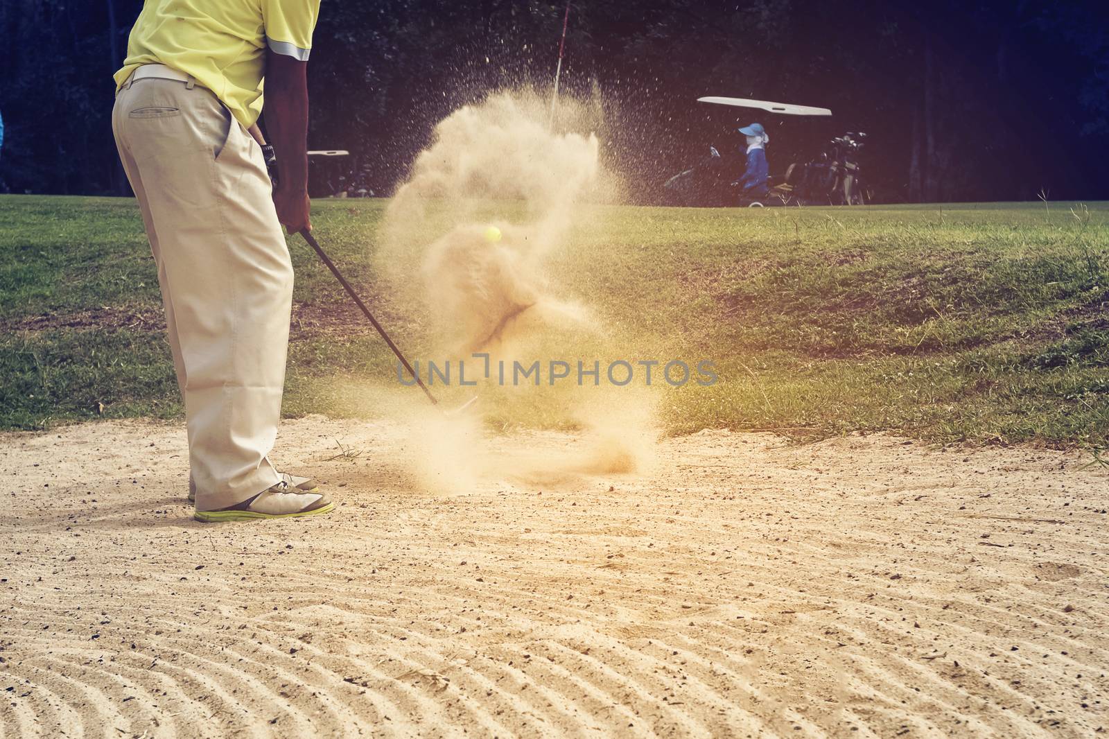 Golfer hitting the ball on the sand to stay on the green. Speeds by numberone9018