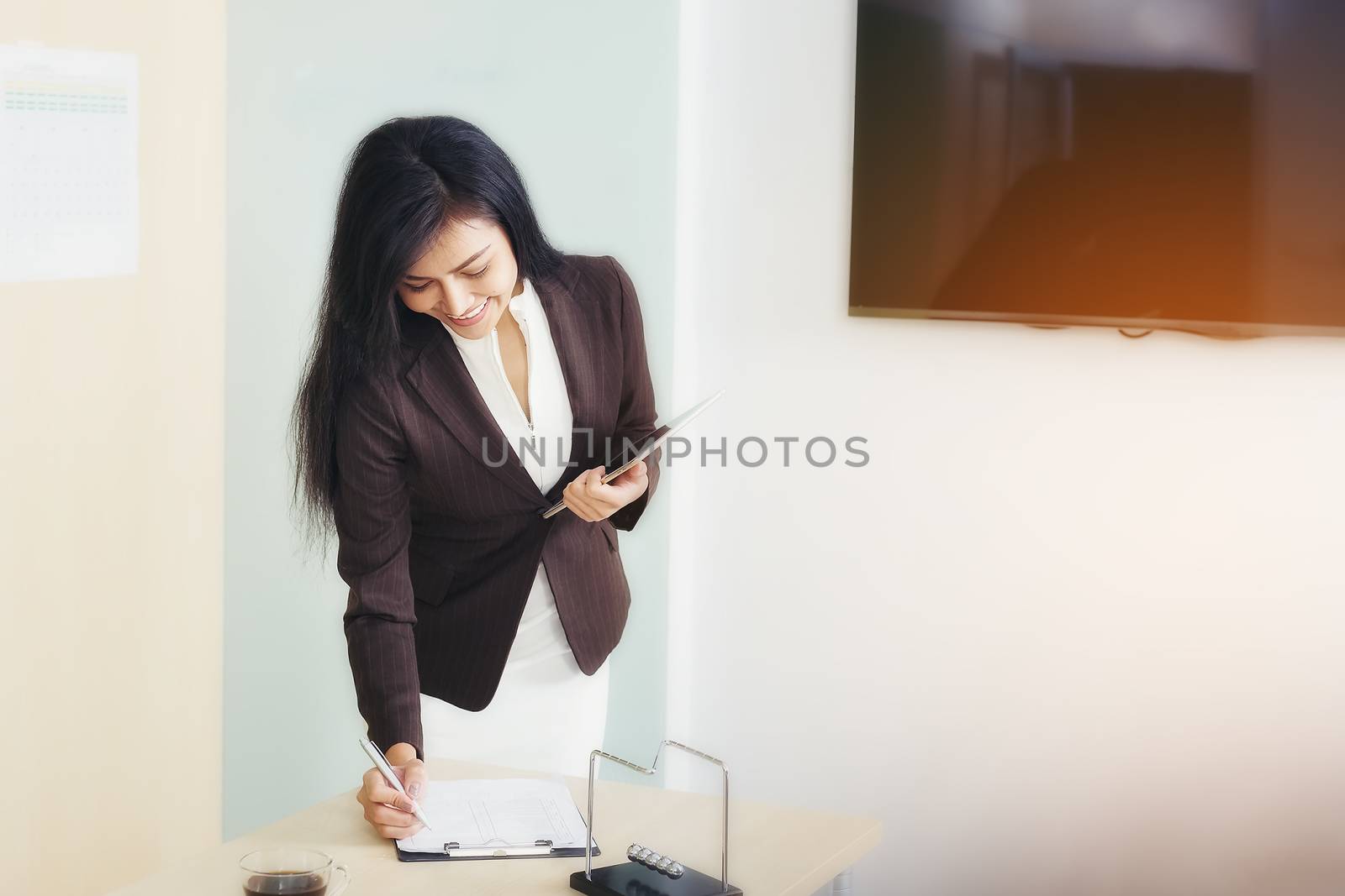 Beautiful young business woman planning to invest in business.